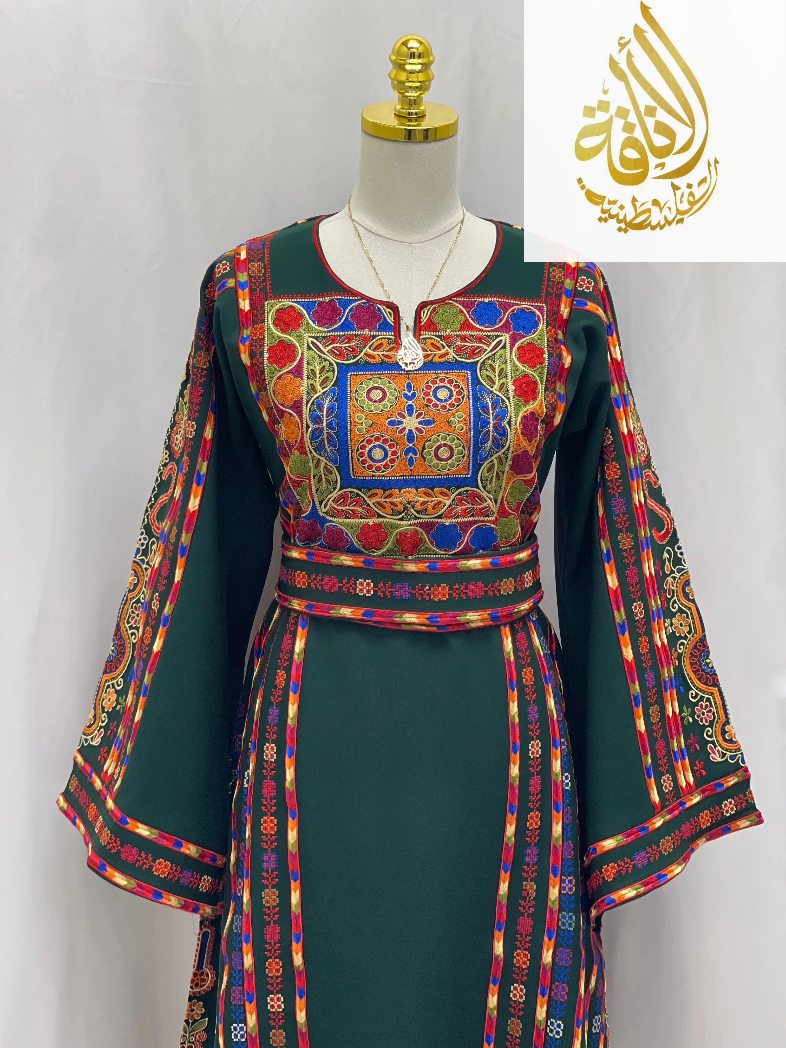 Embroidered Palestinian dress by Palestinian Elegance with colorful traditional embroidery on dark green fabric