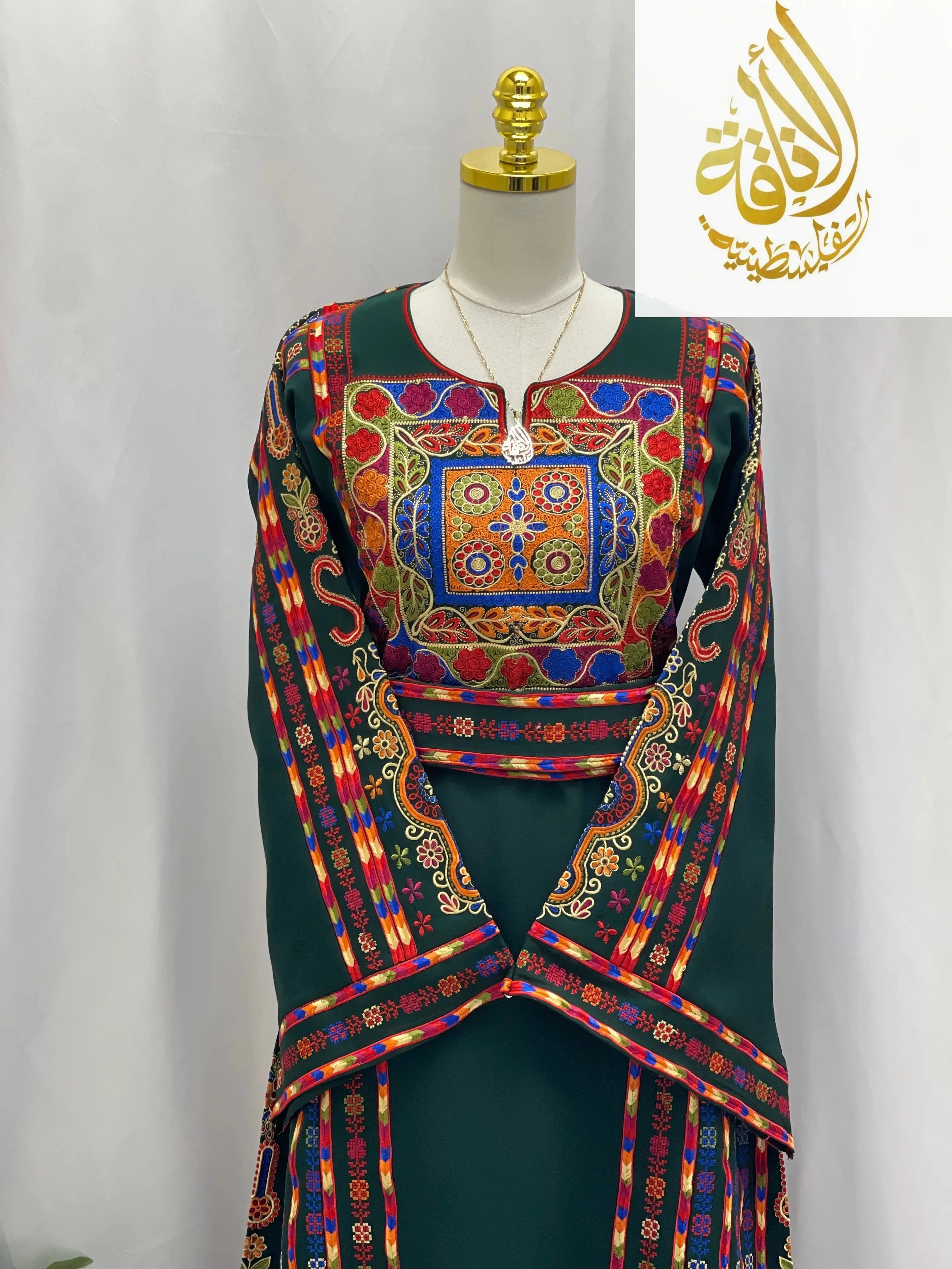 Embroidered Palestinian dress by Palestinian Elegance featuring vibrant multicolor traditional embroidery on dark fabric