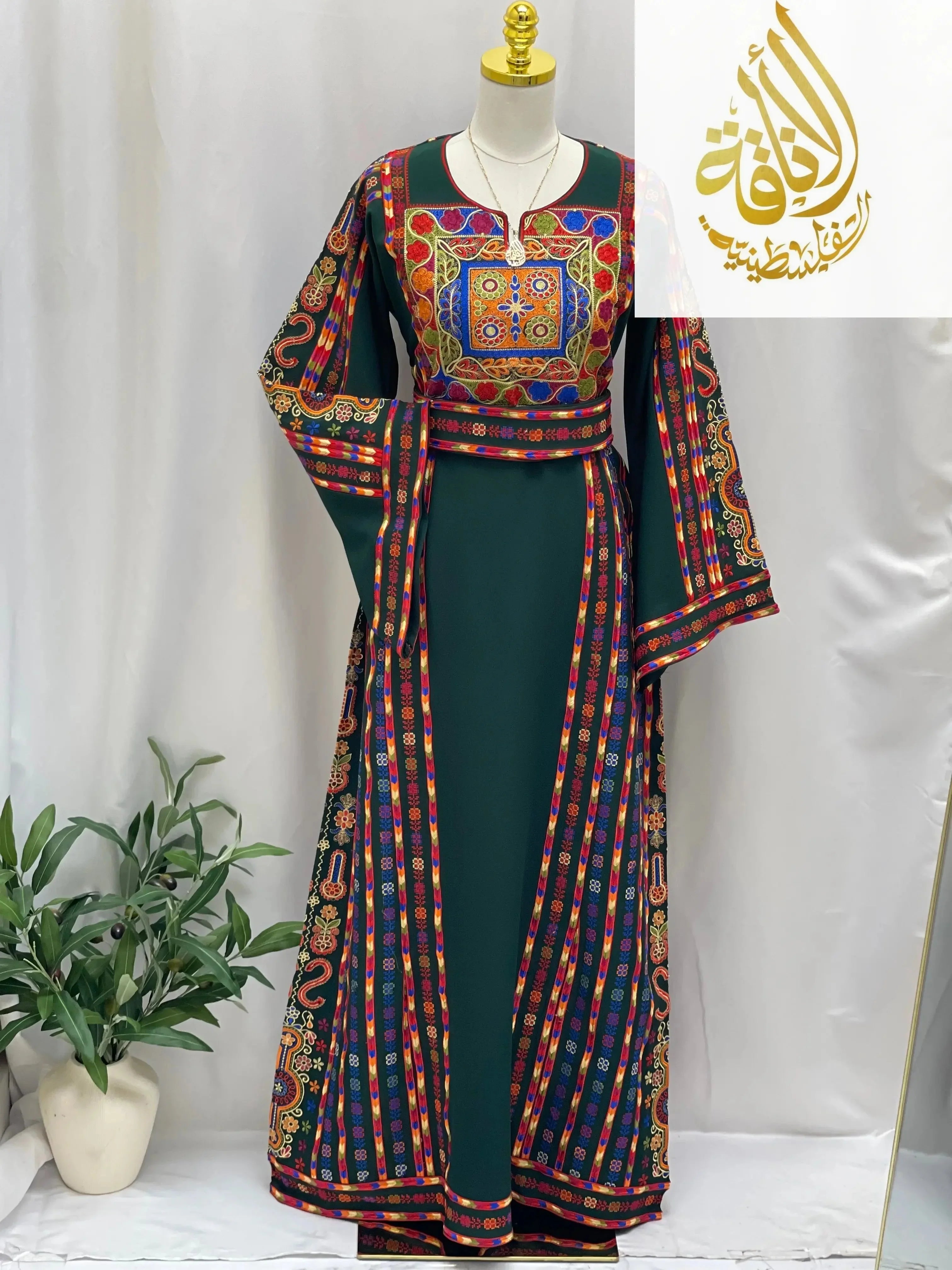 Embroidered Palestinian dress by Palestinian Elegance featuring intricate colorful embroidery on dark fabric with long sleeves