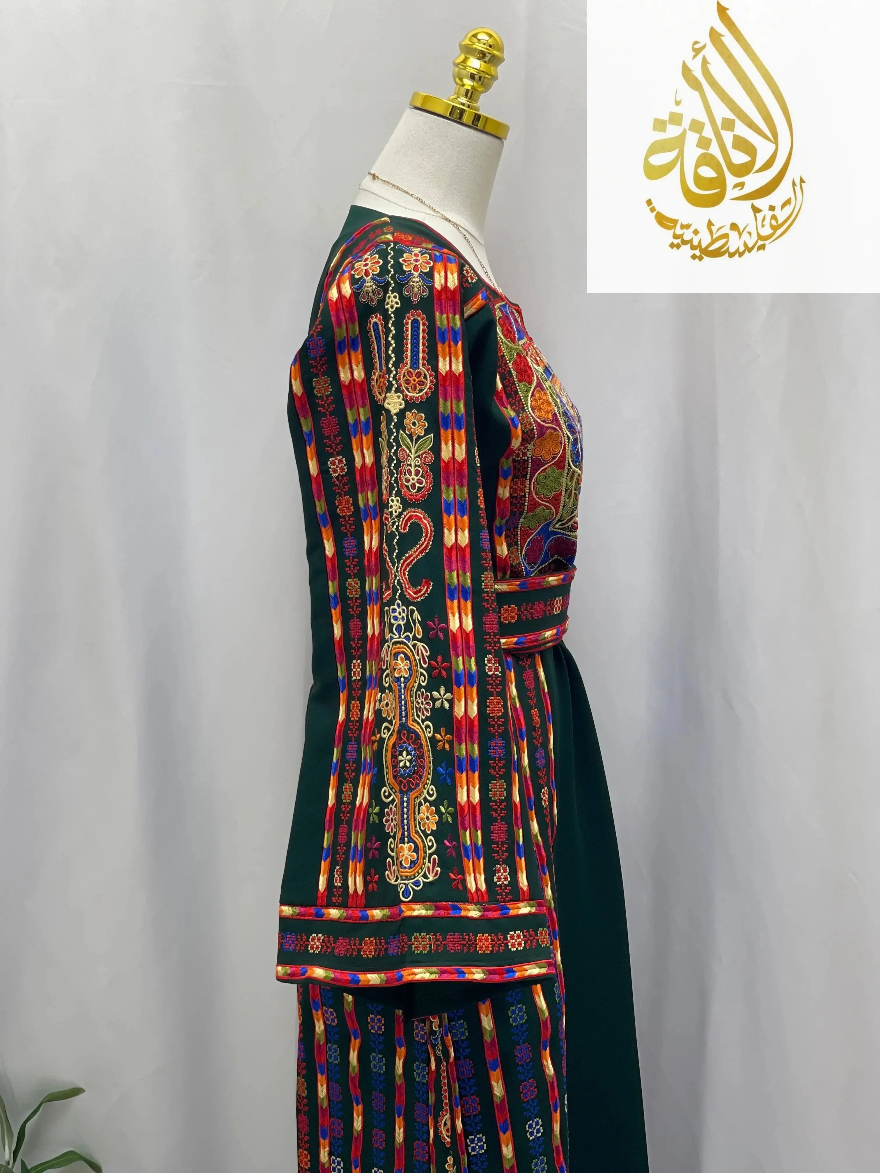Side view of embroidered Palestinian dress by Palestinian Elegance with colorful traditional patterns