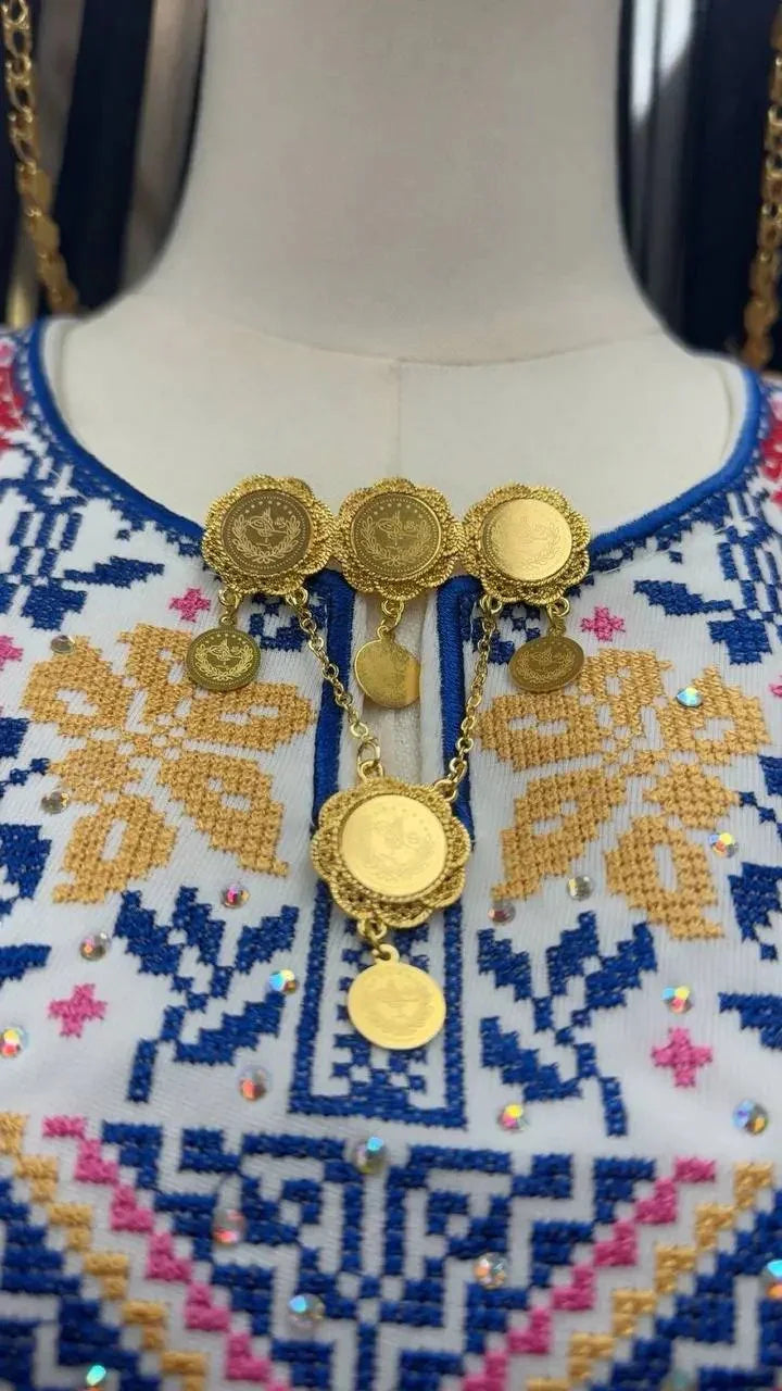 Palestinian Elegance imitated gold traditional gold brooch with intricate coin design on embroidered dress