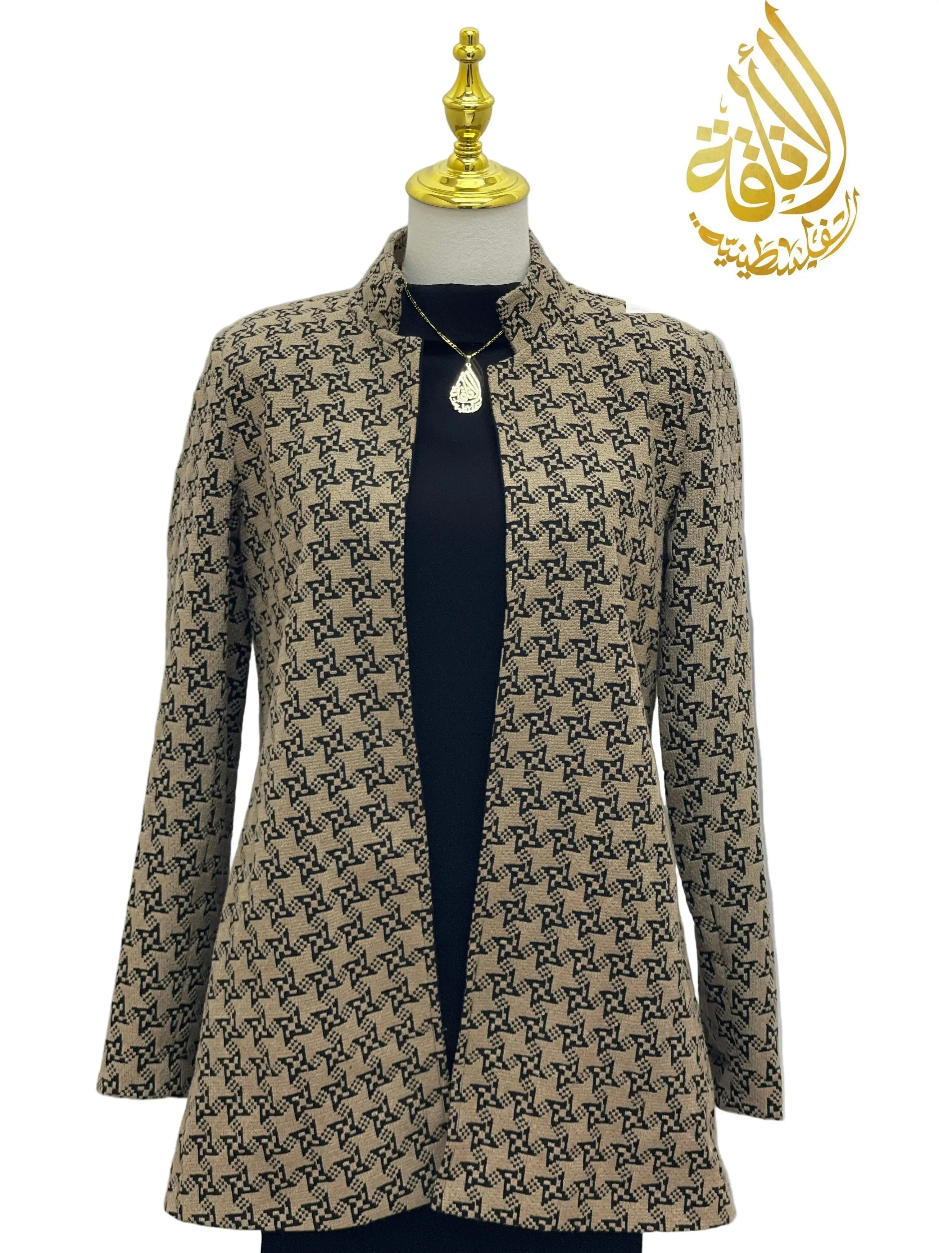 Embroidered Palestinian blazer by Palestinian Elegance in beige with black intricate patterns on a mannequin