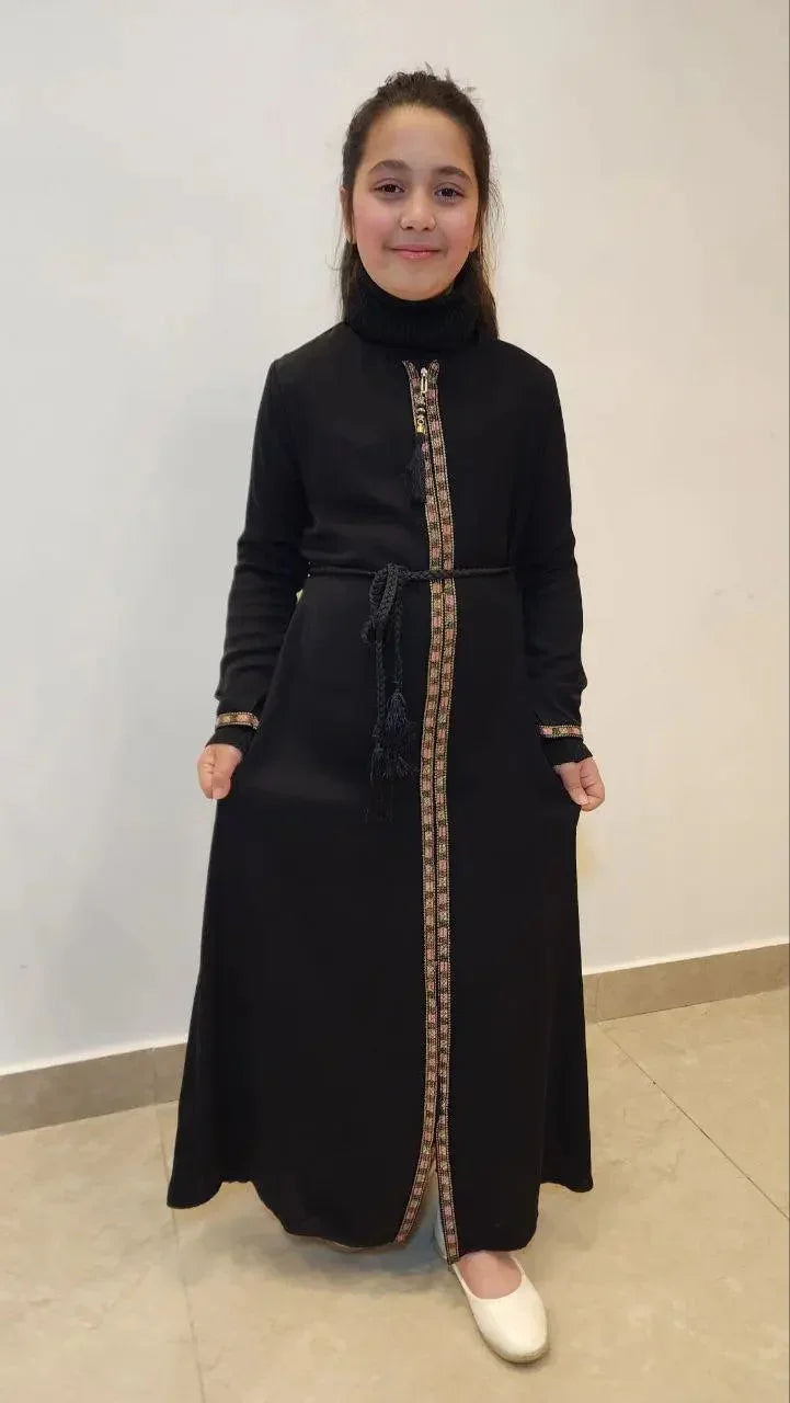 Black embroidered abaya for girls with decorative front trim and tied belt by Palestinian Elegance