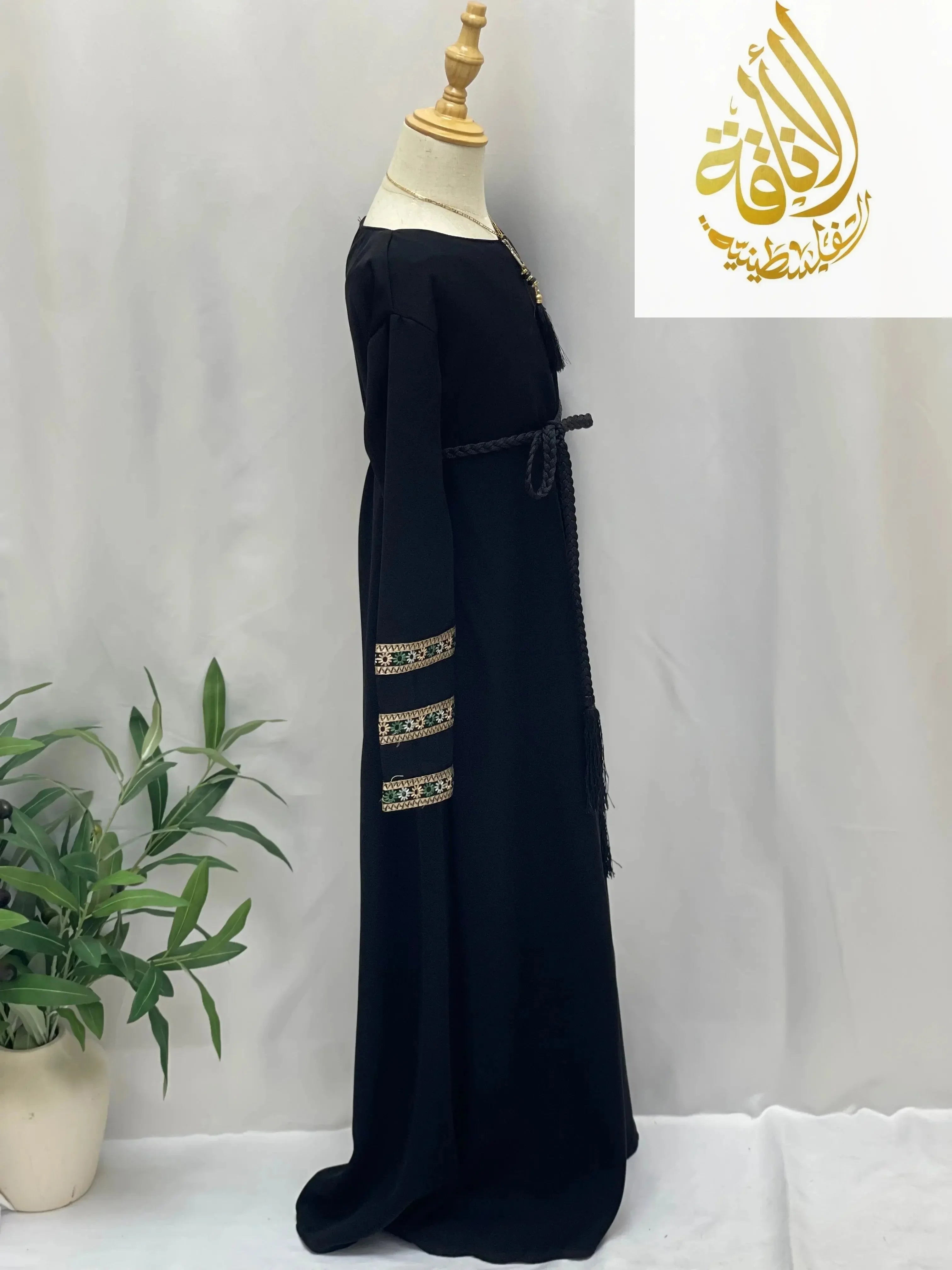 Black embroidered abaya for girls with intricate sleeve detailing and waist tie by Palestinian Elegance