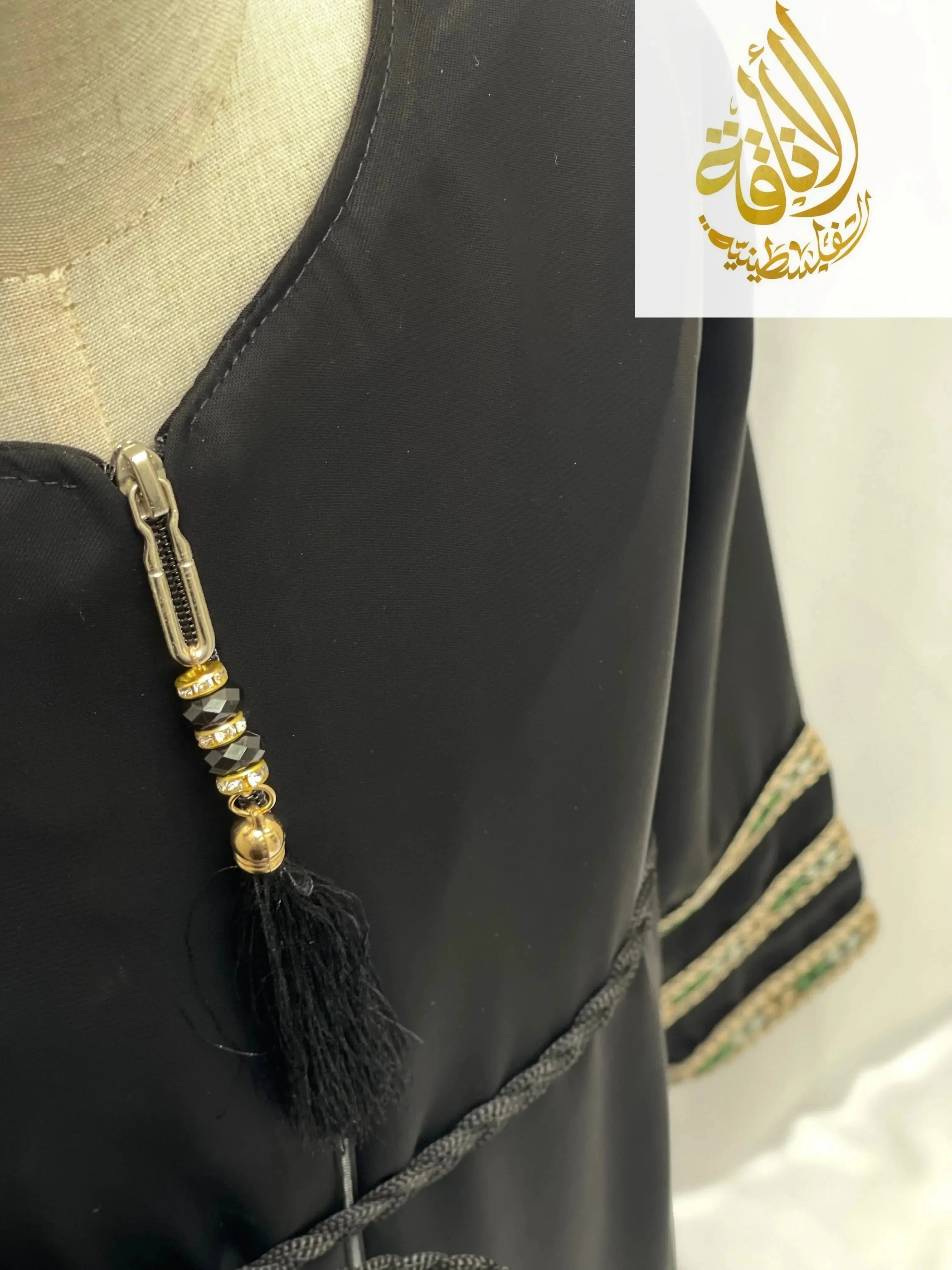 Black embroidered abaya for girls with decorative zipper tassel and intricate sleeve detailing