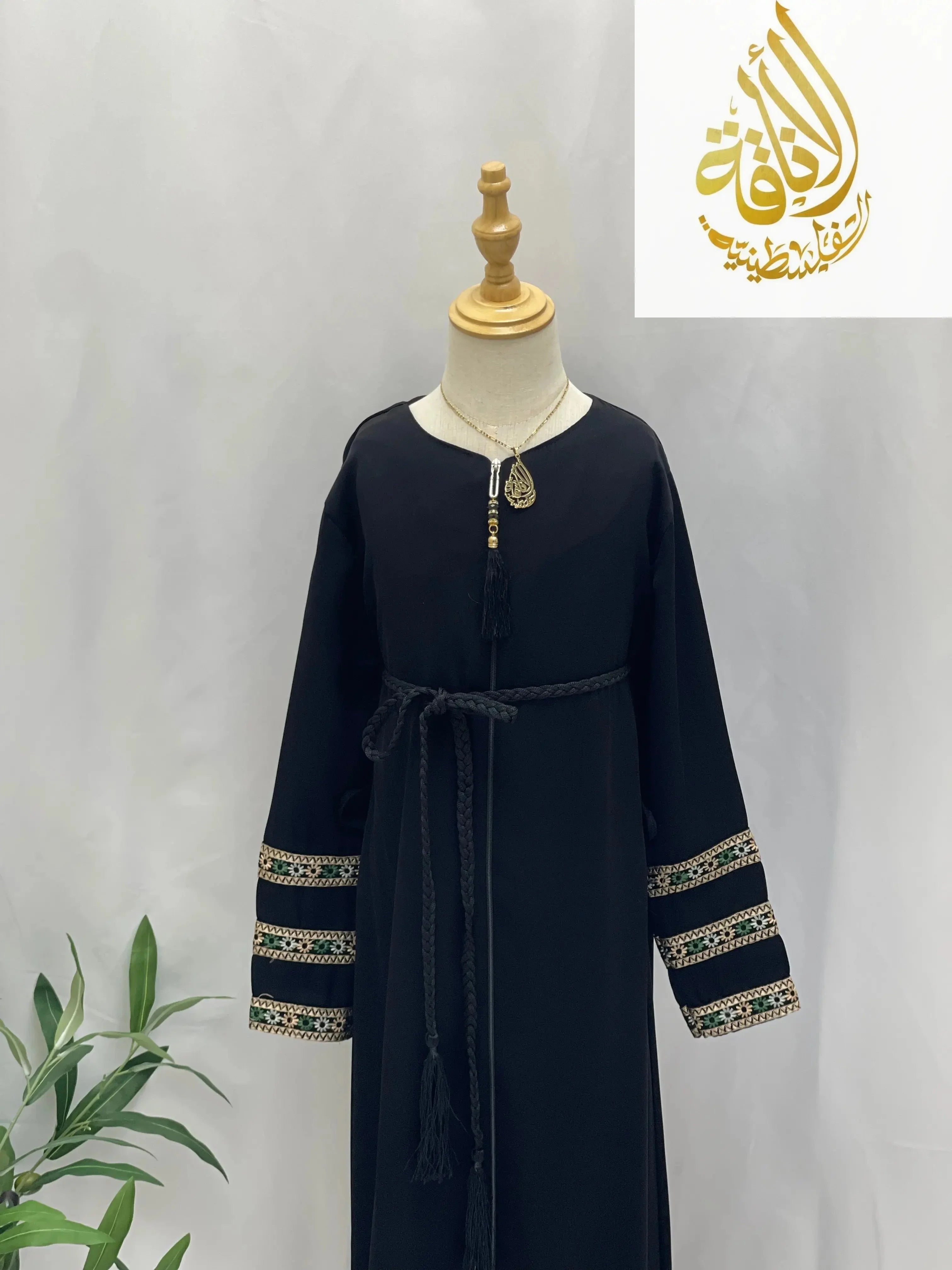 Black embroidered abaya for girls with decorative sleeve cuffs and waist tie from Palestinian Elegance