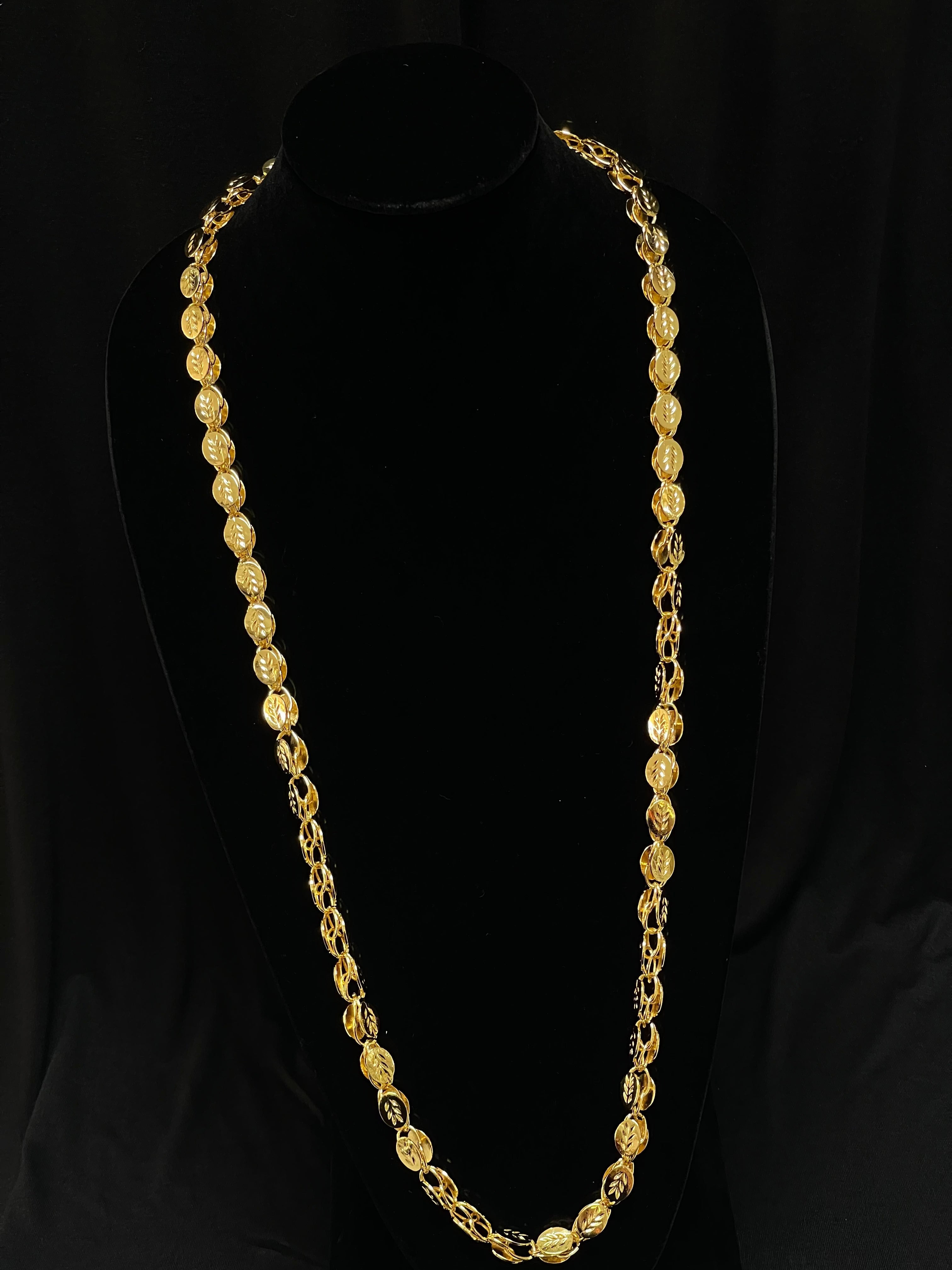 Halabi imitation gold necklace displayed on black stand by Palestinian Elegance