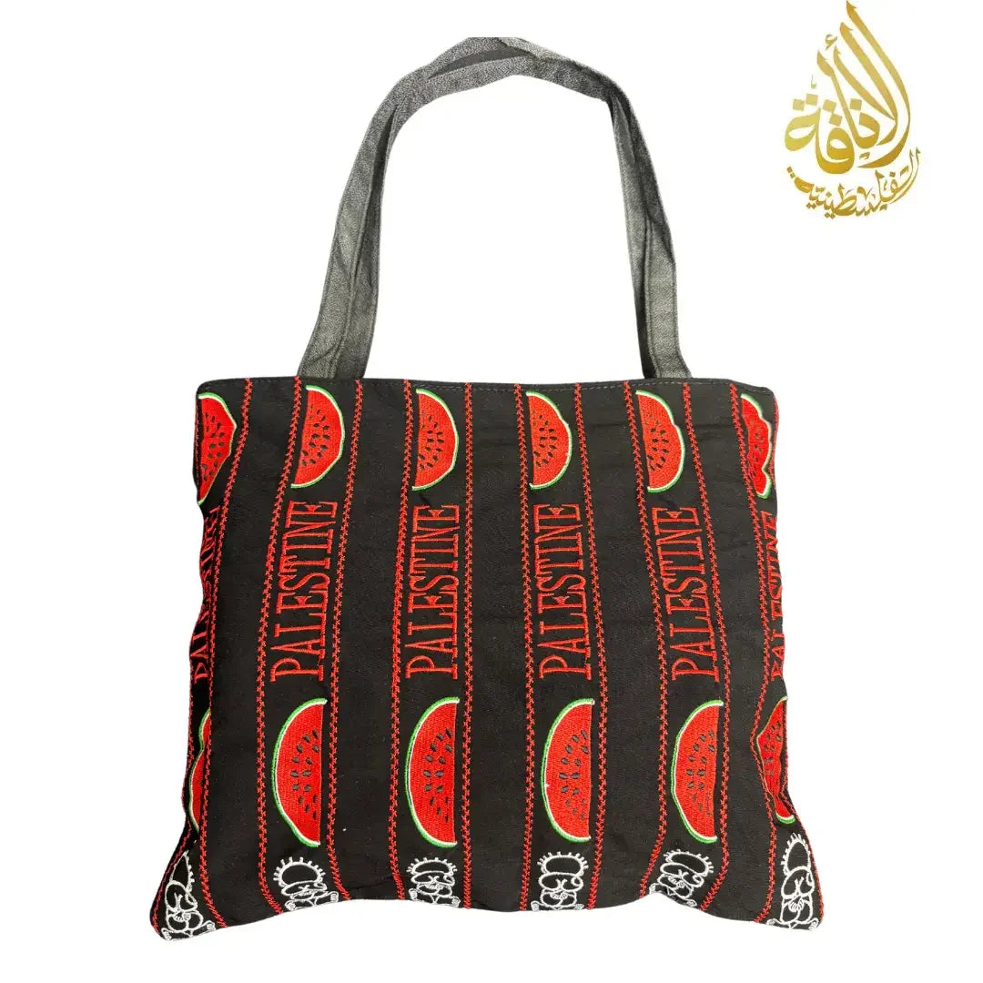 Palestinian tote bag with black fabric, red watermelon patterns, and gray handles by Palestinian Elegance