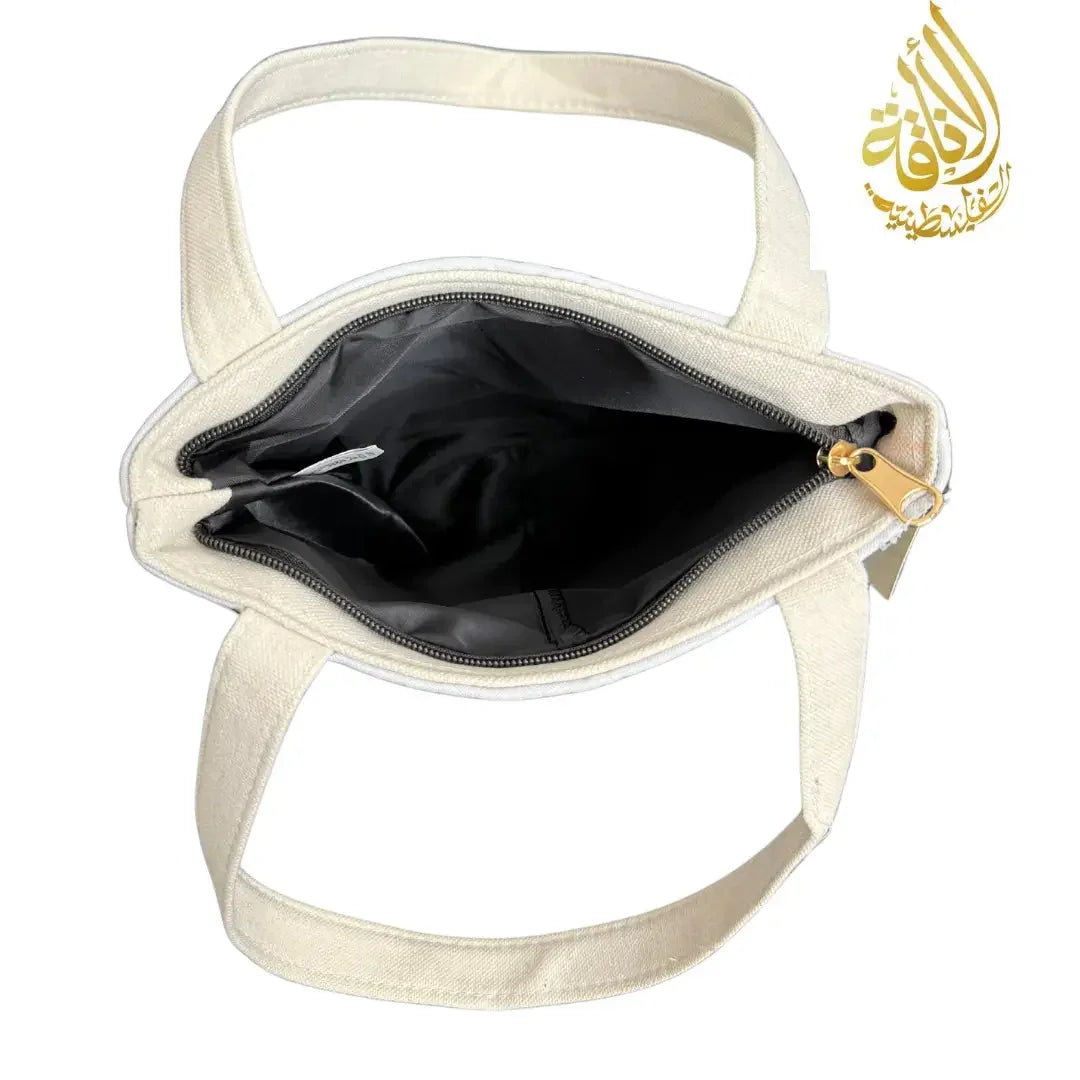 Interior view of Palestinian embroidered tote bag with black lining and gold zipper