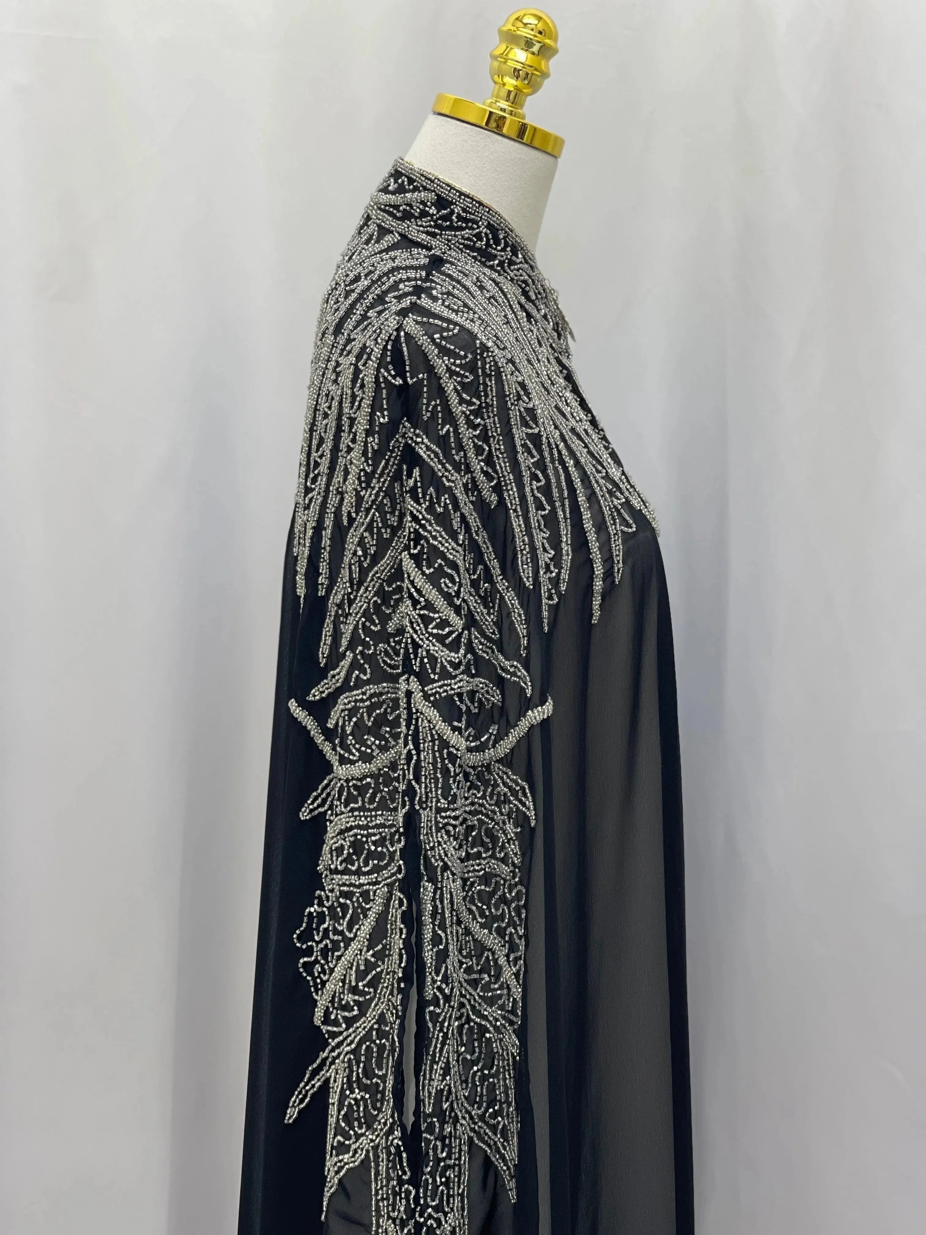 Black traditional embroidery cape with intricate silver thread detailing from Palestinian Elegance