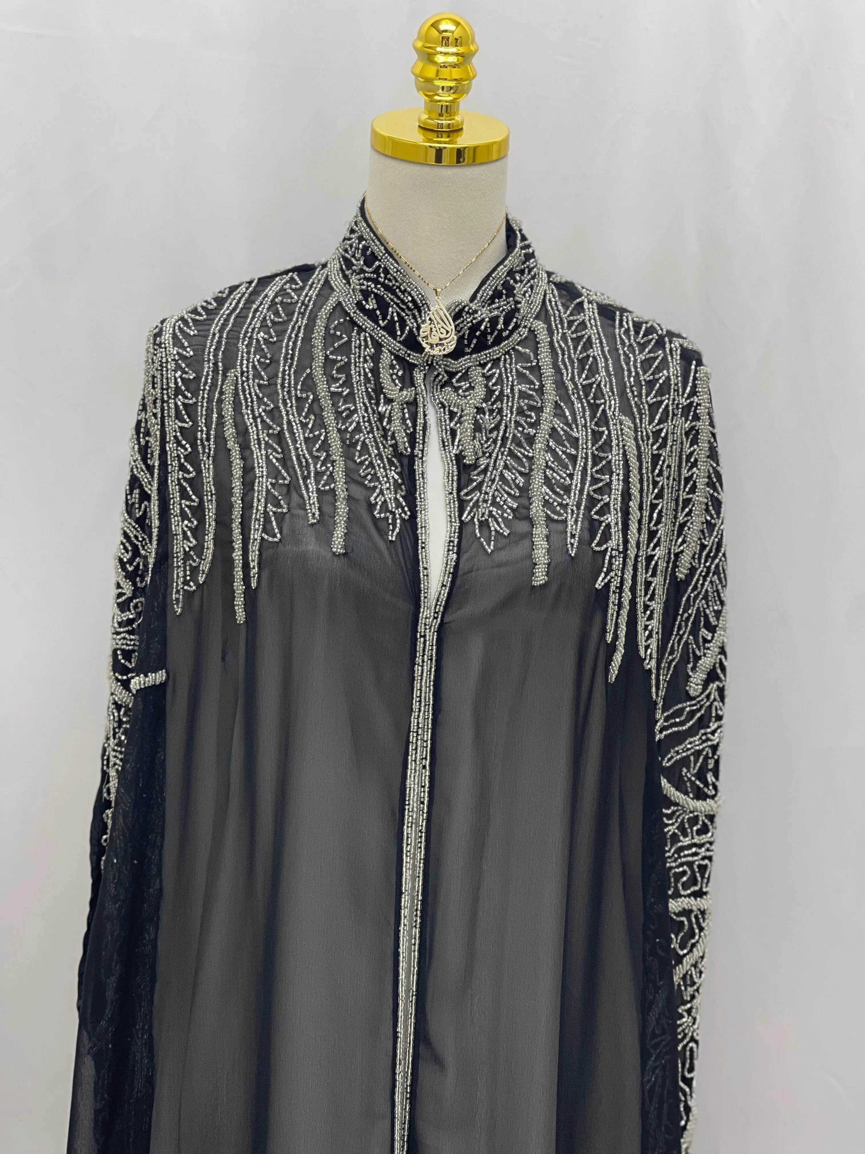 Palestinian Elegance traditional embroidery cape in black with intricate silver thread detailing on collar and shoulders