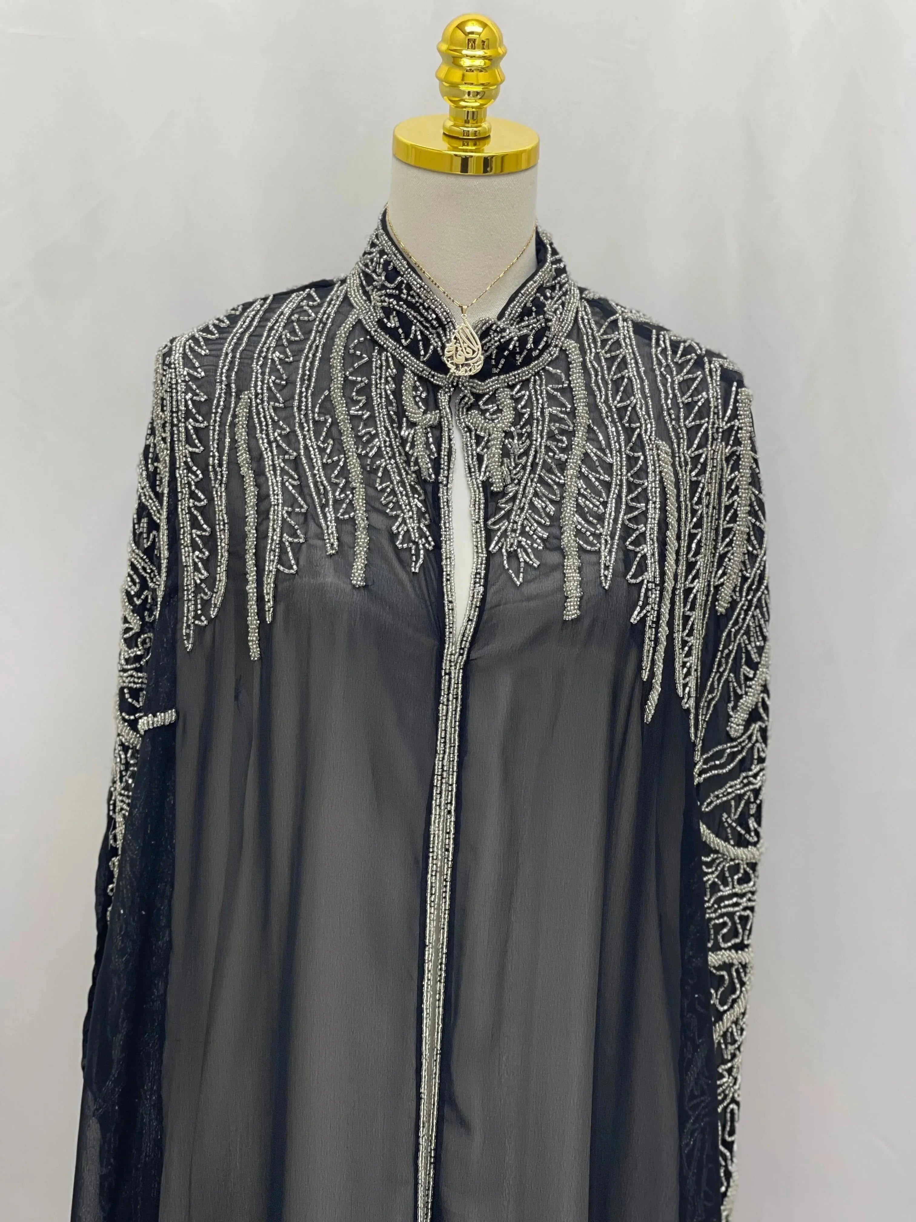 Palestinian Elegance traditional embroidery cape in black with intricate silver thread detailing on collar and shoulders