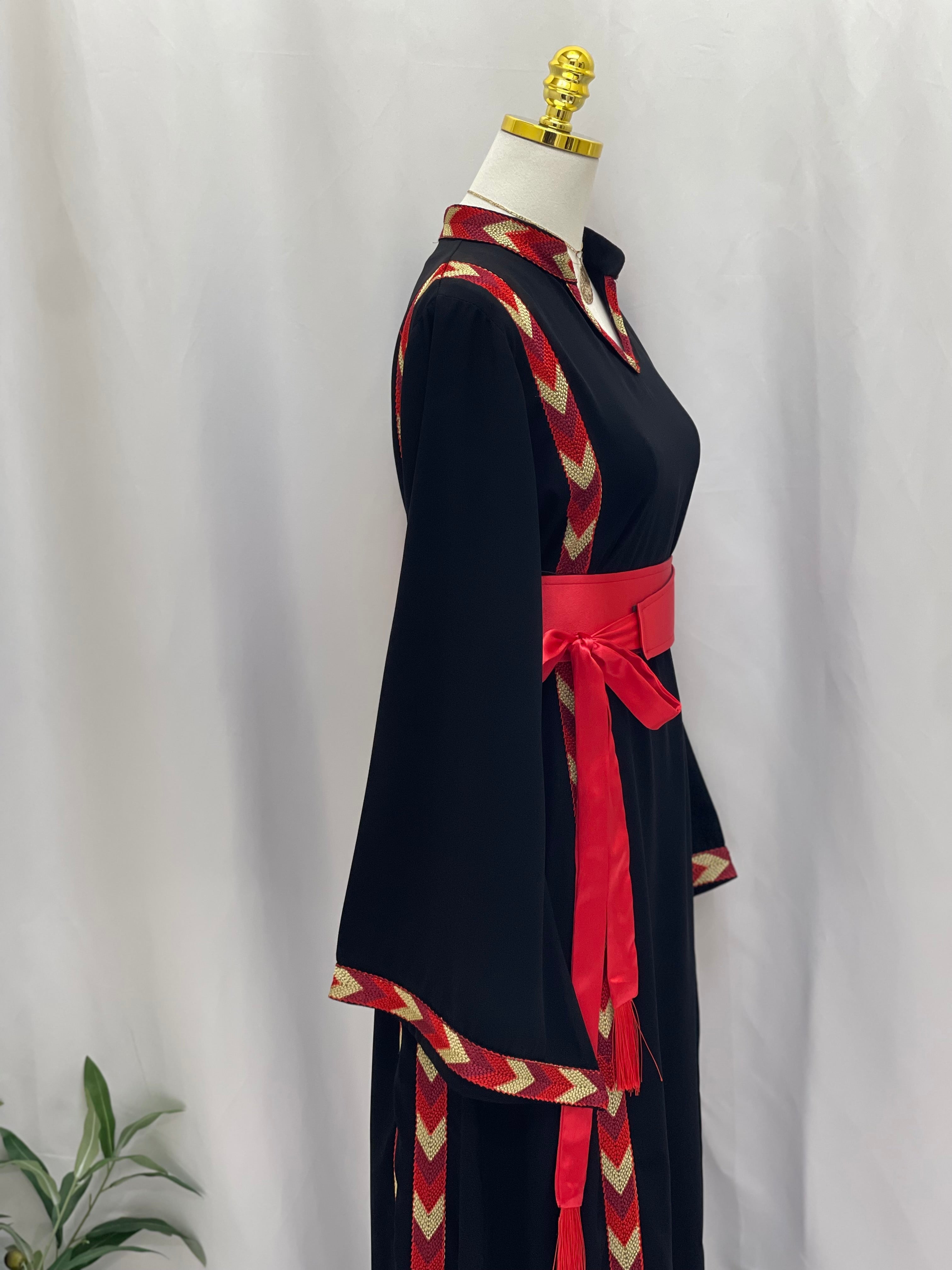 Traditional Palestinian thobe with black fabric and red embroidered trim by Palestinian Elegance