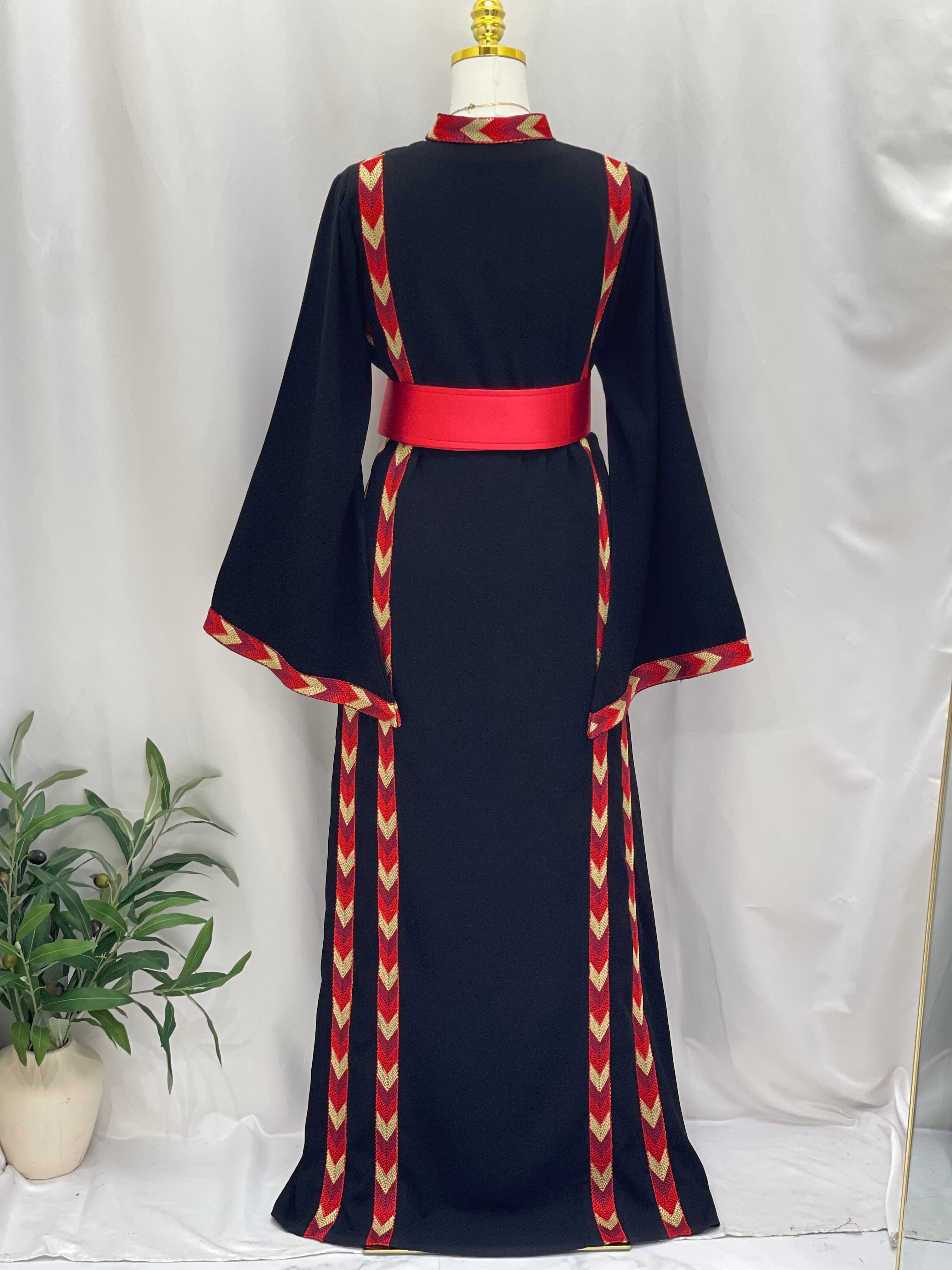 Traditional Palestinian thobe embroidery by Palestinian Elegance in black with red and gold accents and wide sleeves