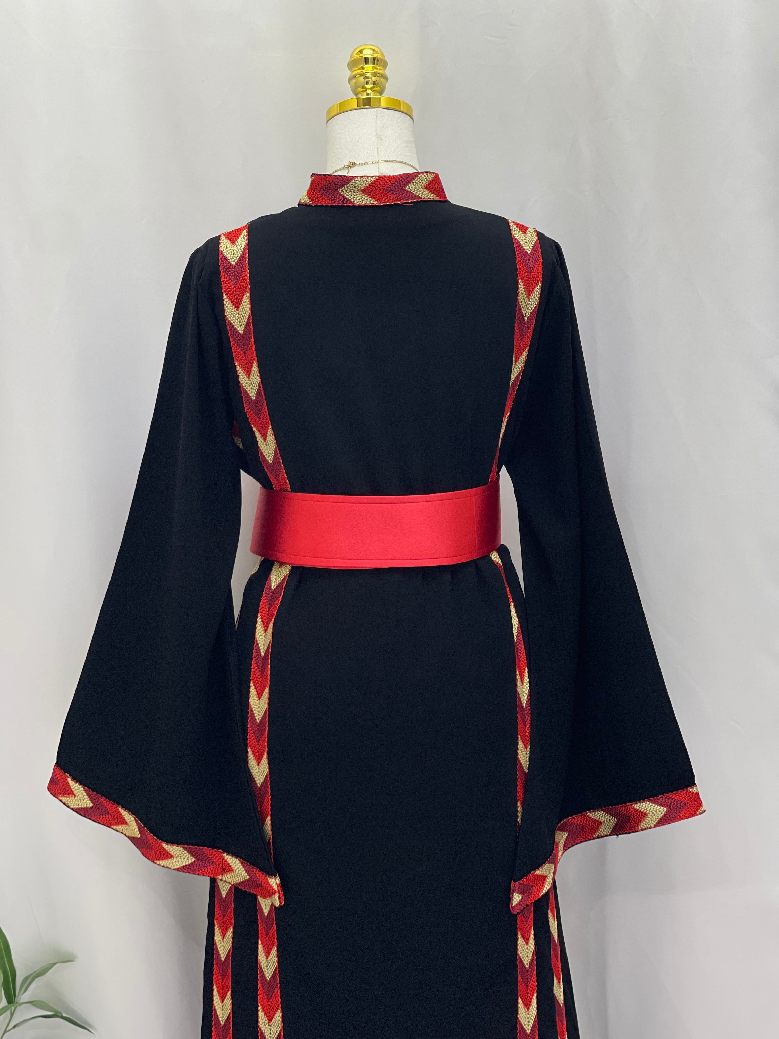 Back view of traditional Palestinian thobe embroidery with red and beige geometric patterns on black fabric