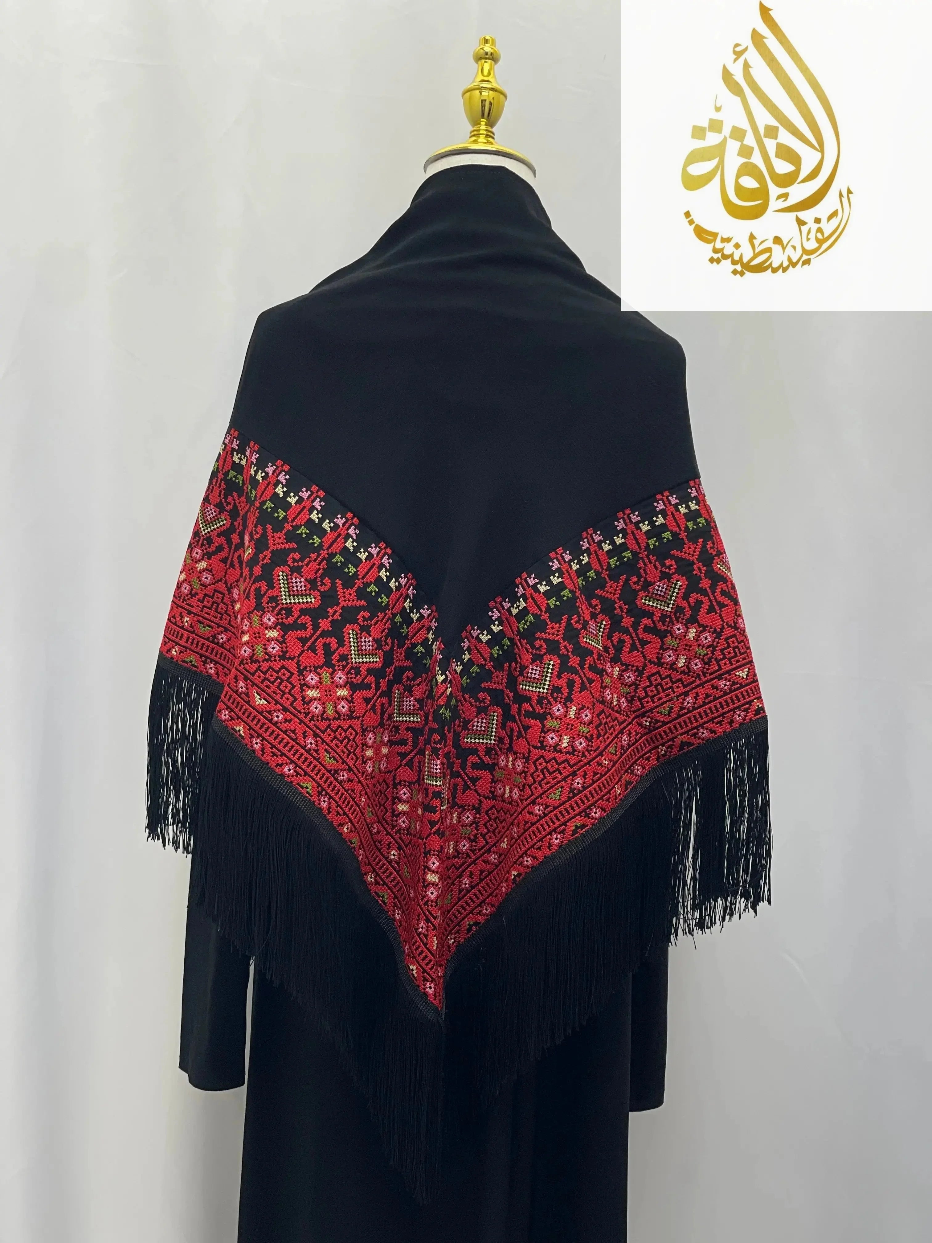 Black Palestinian embroidered shawl with red traditional designs and fringe detail from Palestinian Elegance