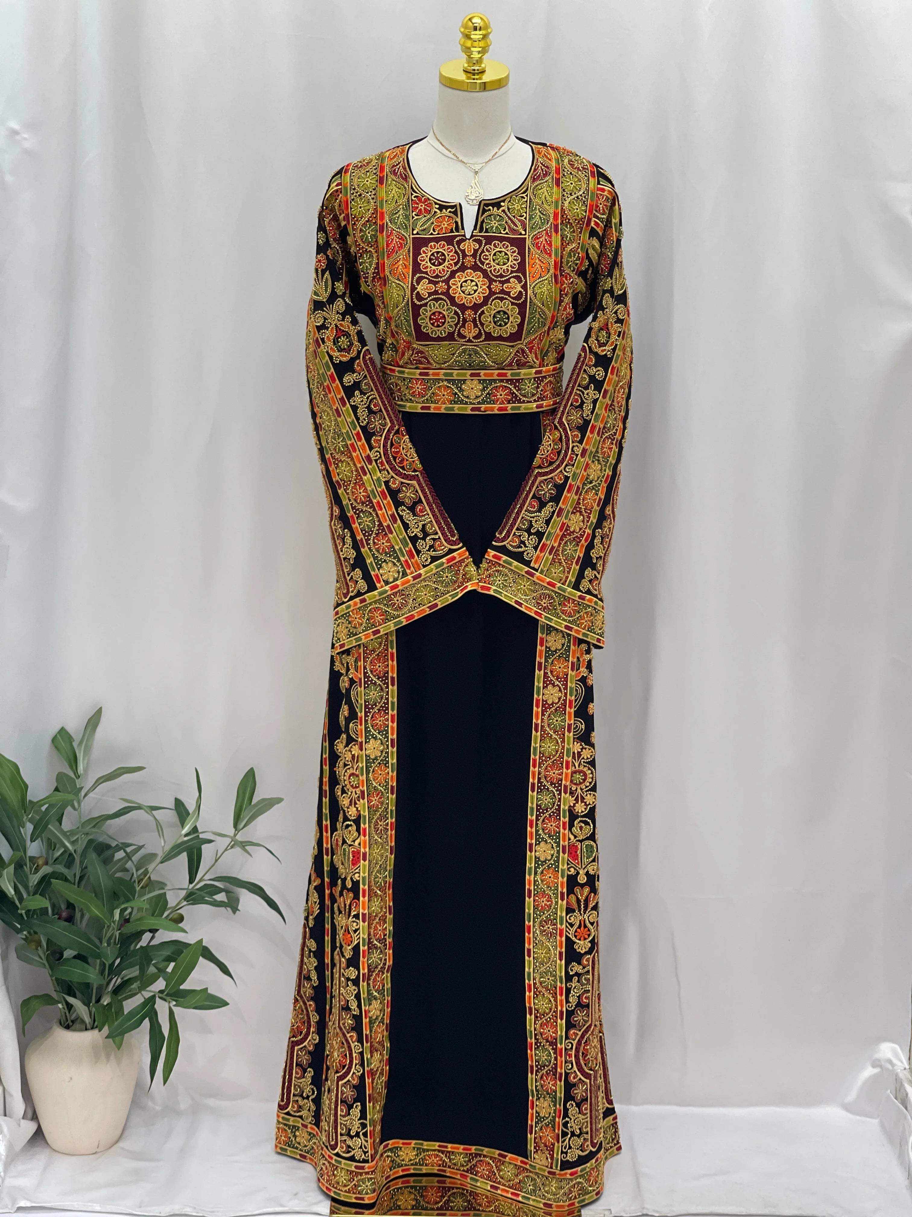 Palestinian Thoub with Beaded Embroidery long black traditional embroidered dress with red gold floral panels on mannequin