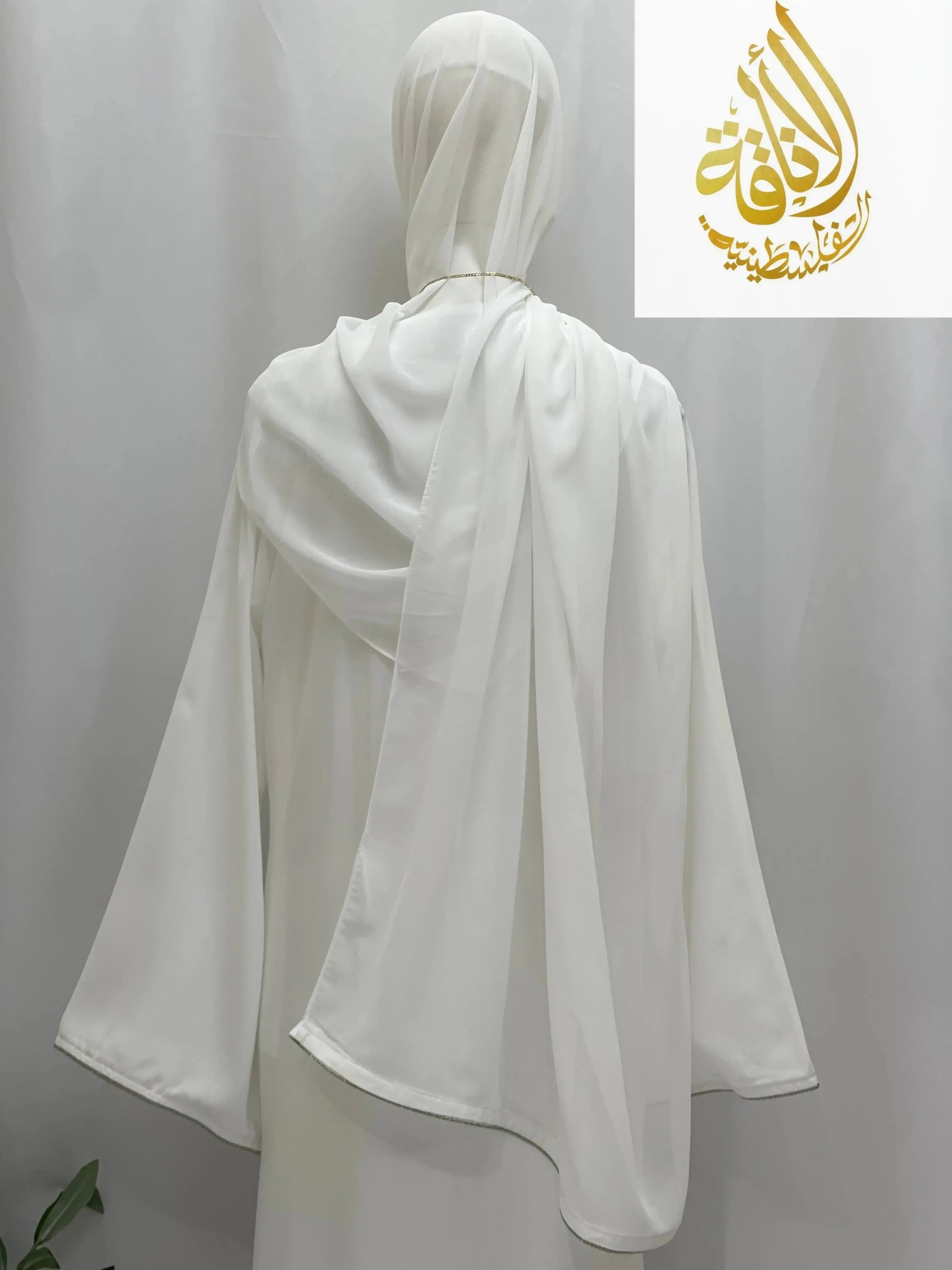 Modest umra abaya with hijab in white from Palestinian Elegance shown from the back with flowing fabric