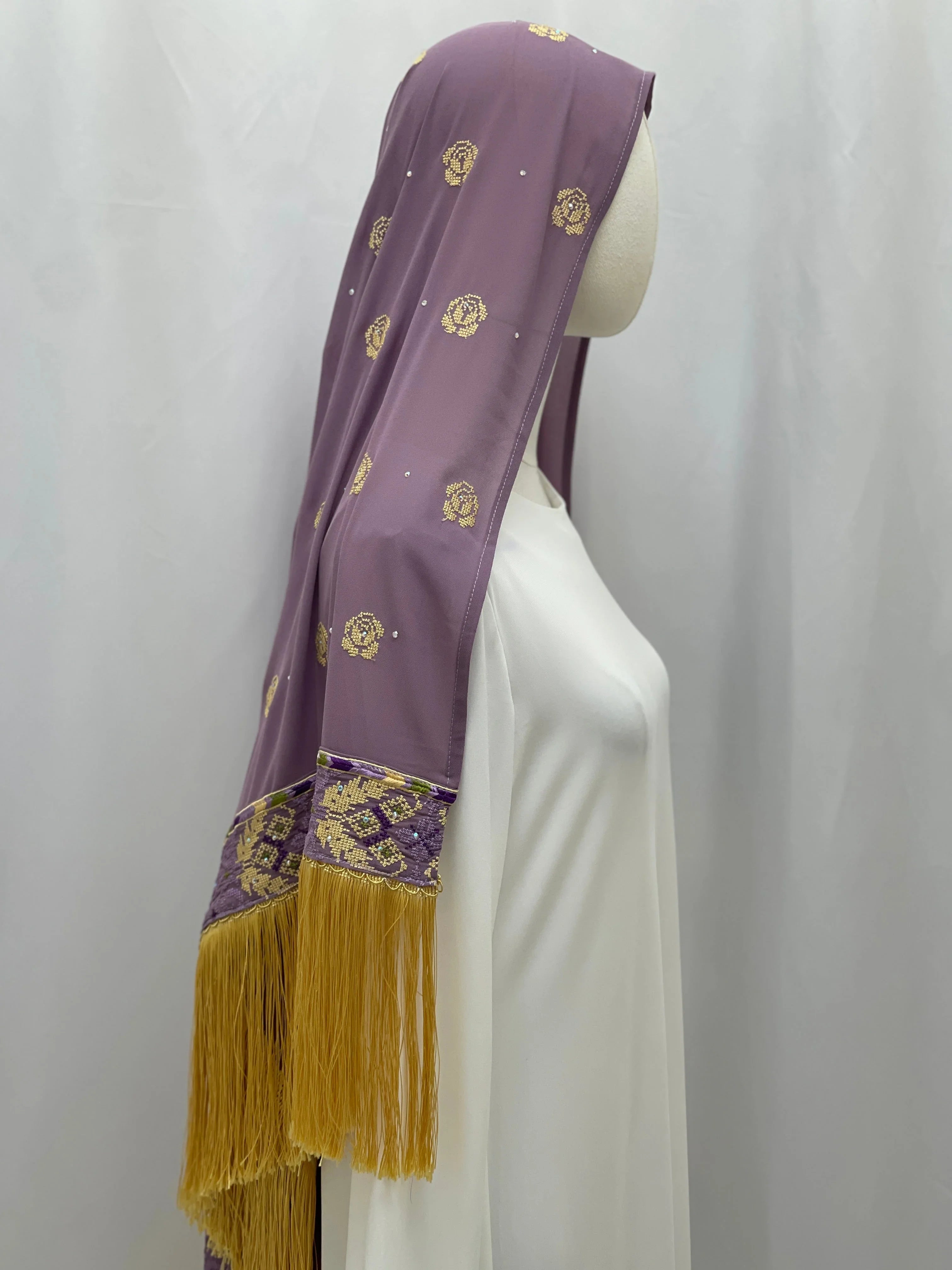 Warda Al-Karmeh Khirka-Shwal in purple with intricate patterns and golden fringe for elegant style