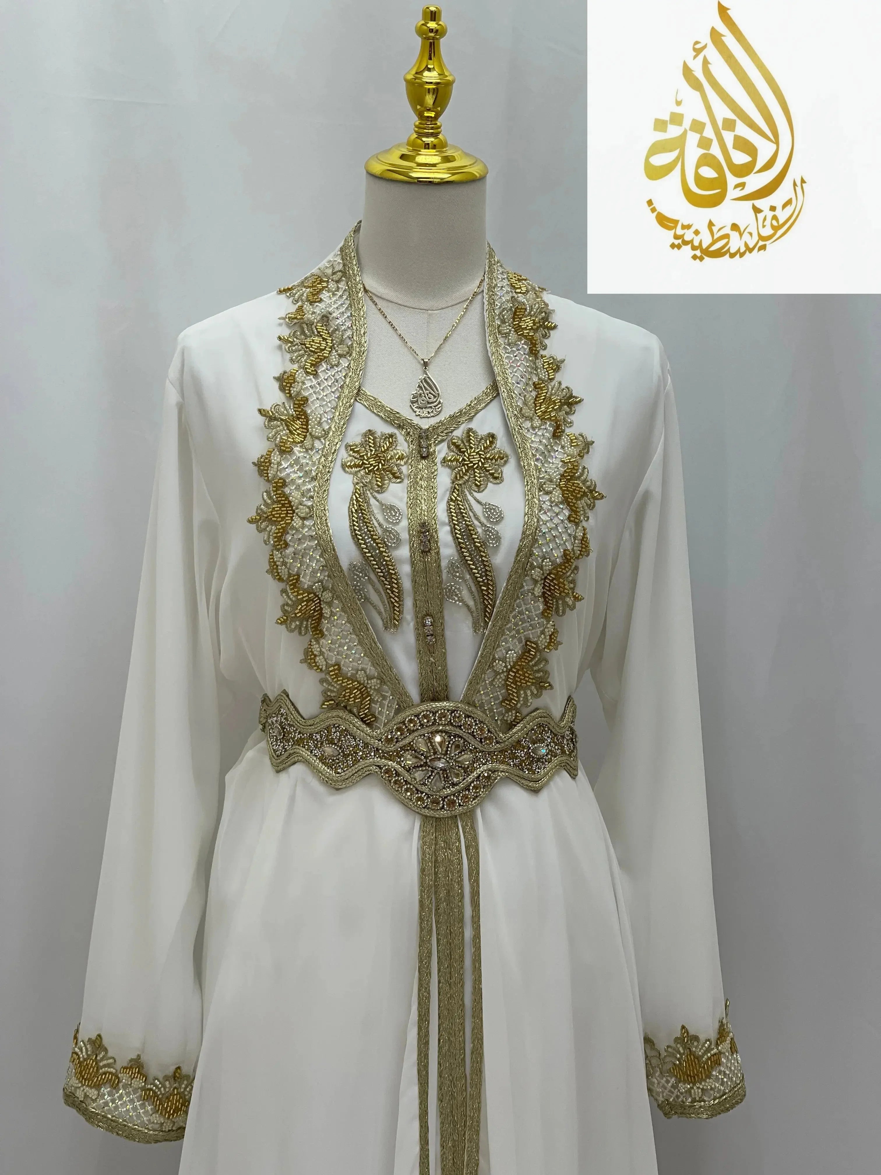 White Moroccan Style Kaftan with detailed gold embroidery and decorative belt by Palestinian Elegance