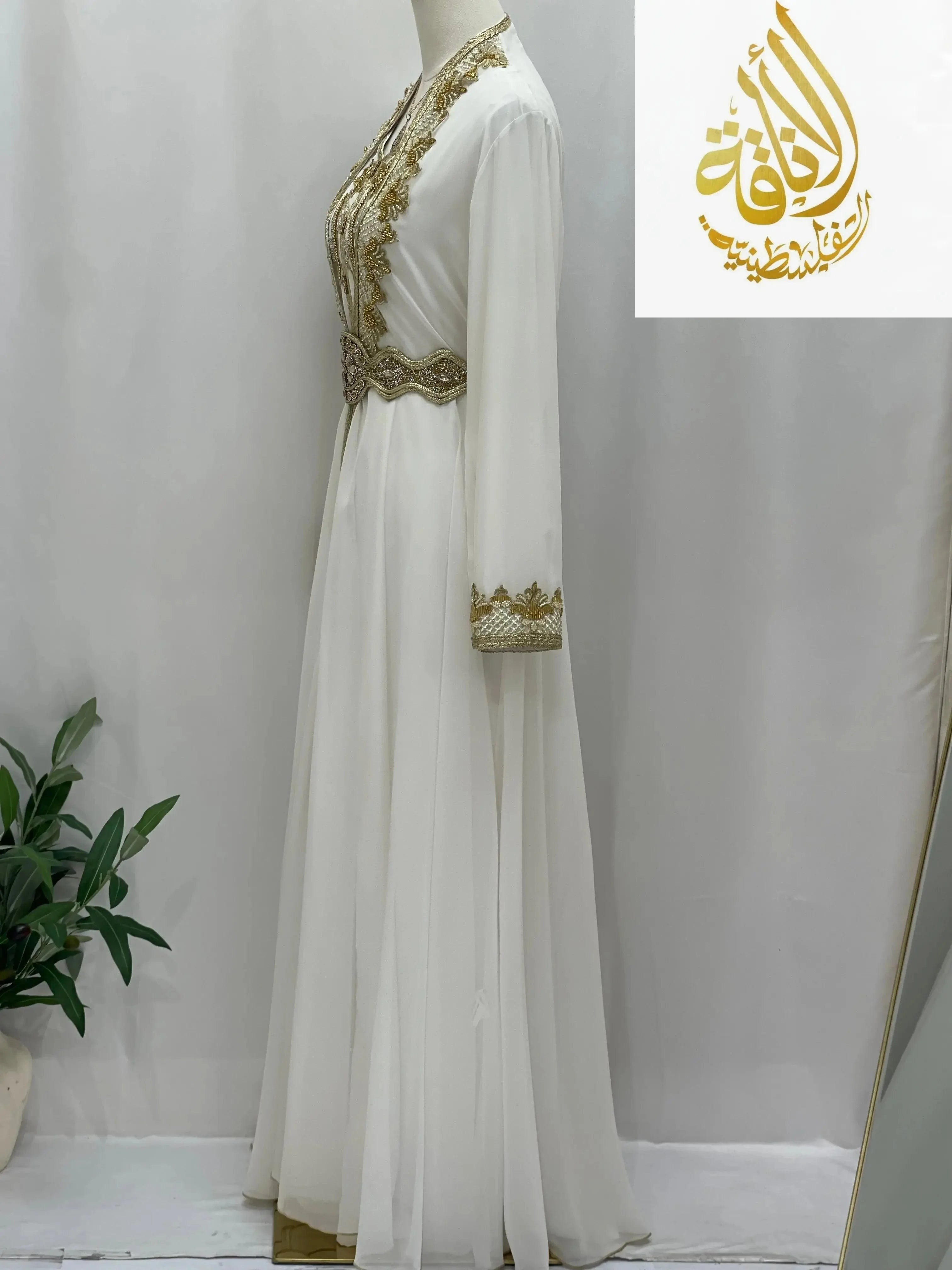 White Palestinian Elegance Moroccan Style Kaftan with gold embroidery and long sleeves on mannequin
