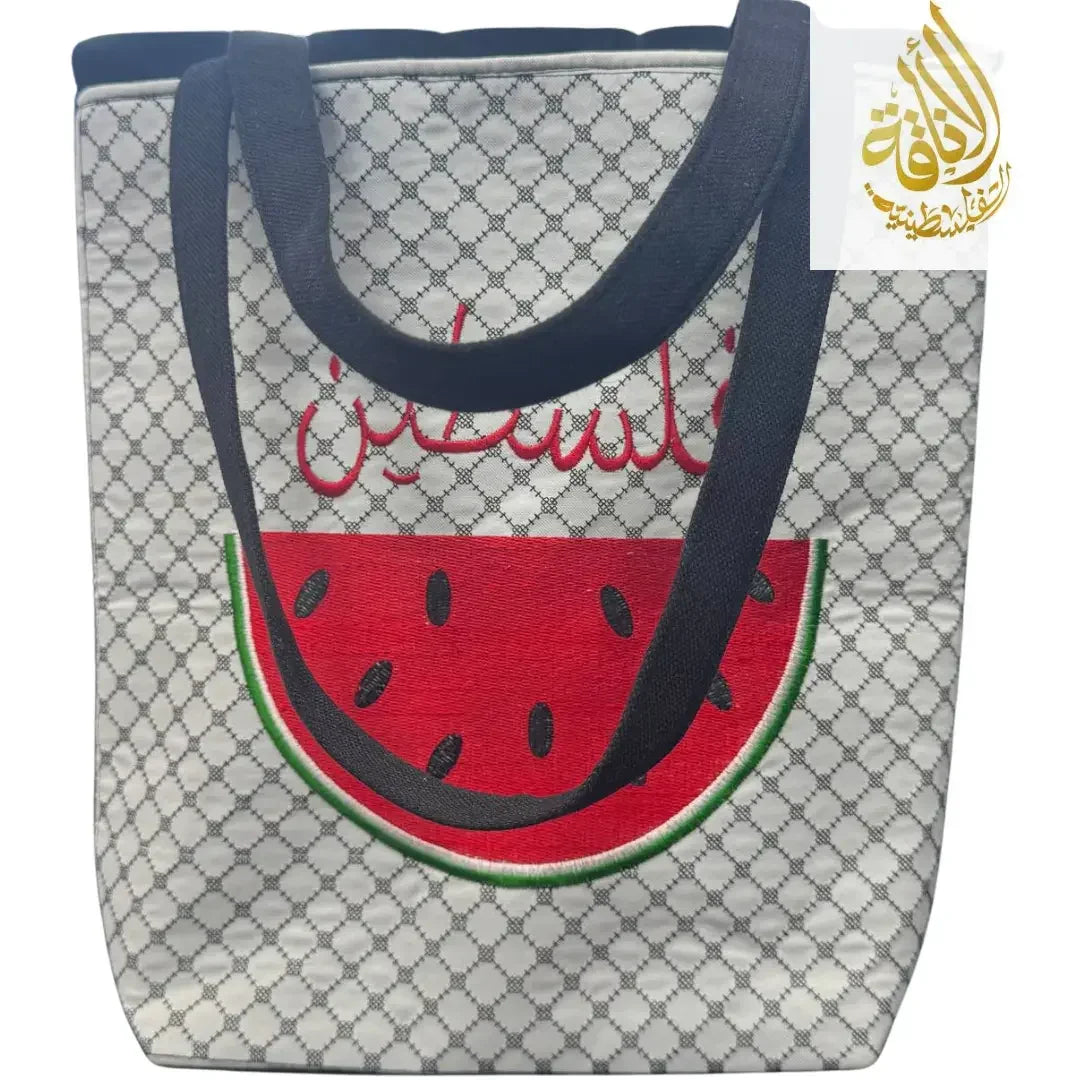 Palestinian embroidered tote bag with black handles and watermelon design on patterned background
