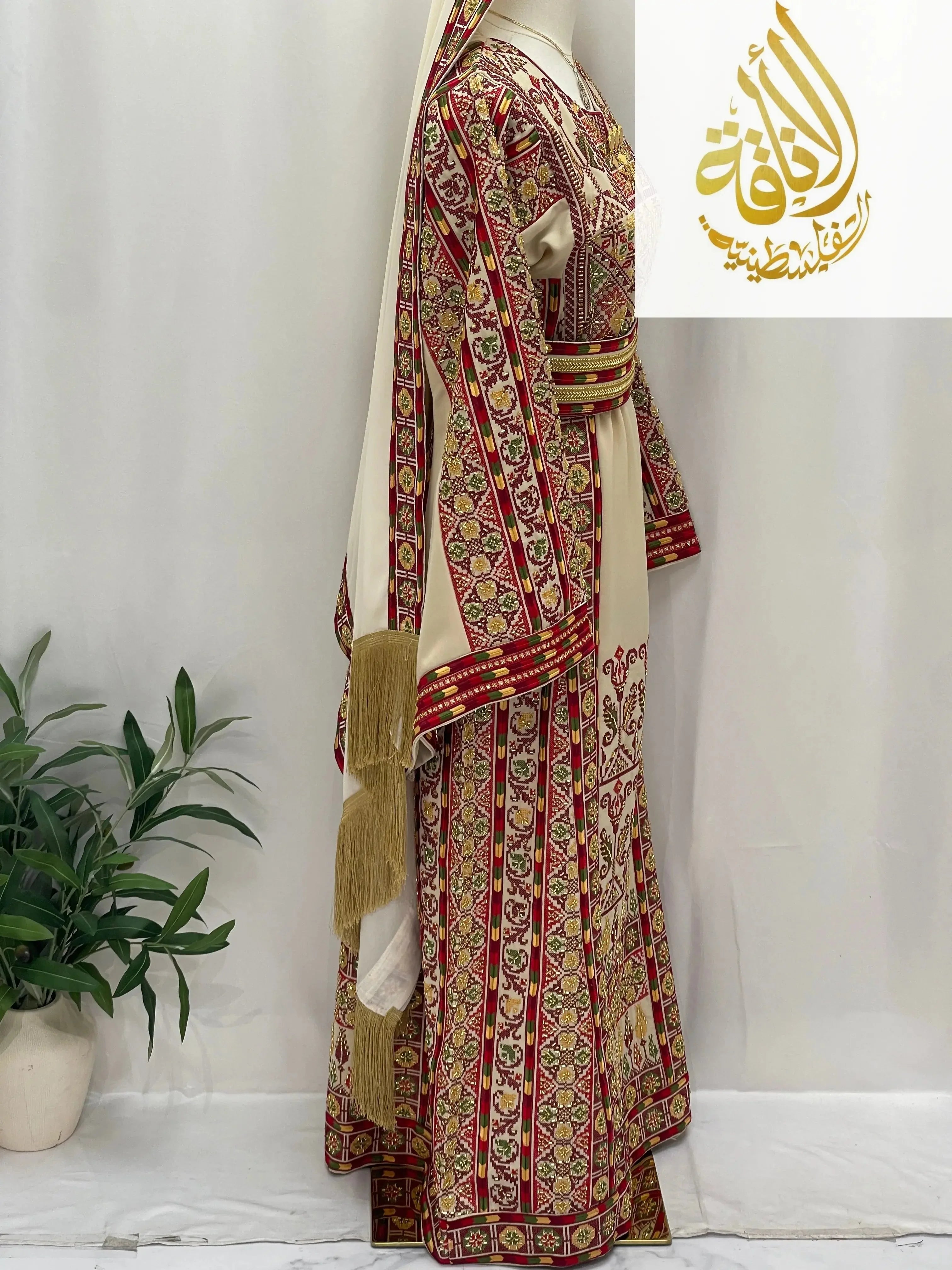 Palestinian Elegance Gold Beads Thoub with intricate gold and red embroidery on beige fabric displayed on mannequin