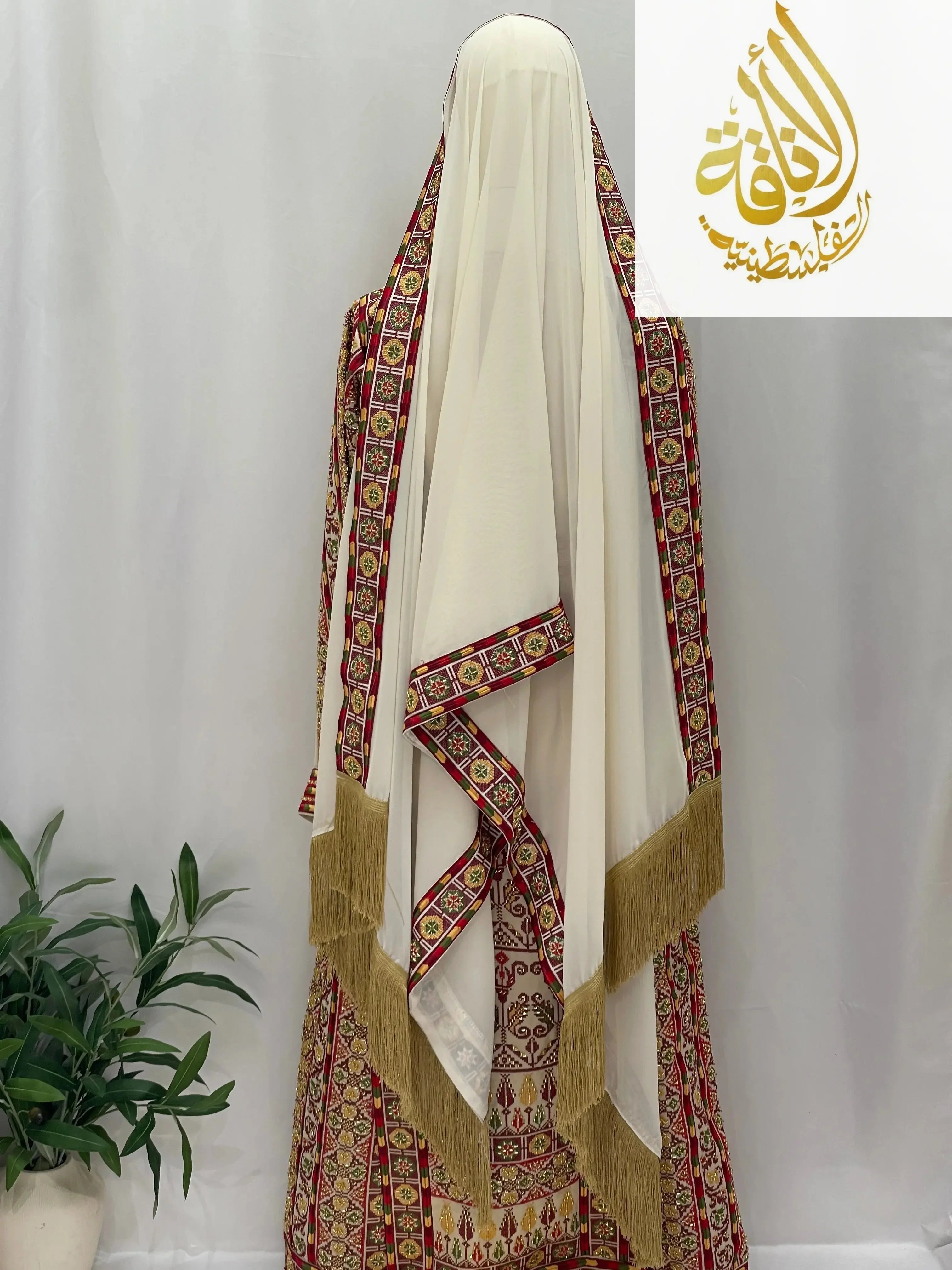 Palestinian Elegance Gold Beads Thoub in cream with intricate red and gold embroidered borders and fringe detailing