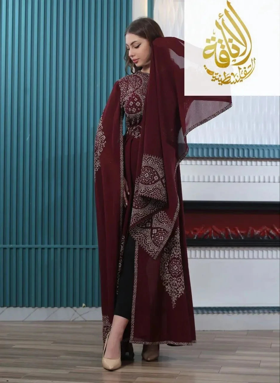 Palestinian Elegance embroidered kaftan dress in deep burgundy with intricate white patterns and flowing sleeves
