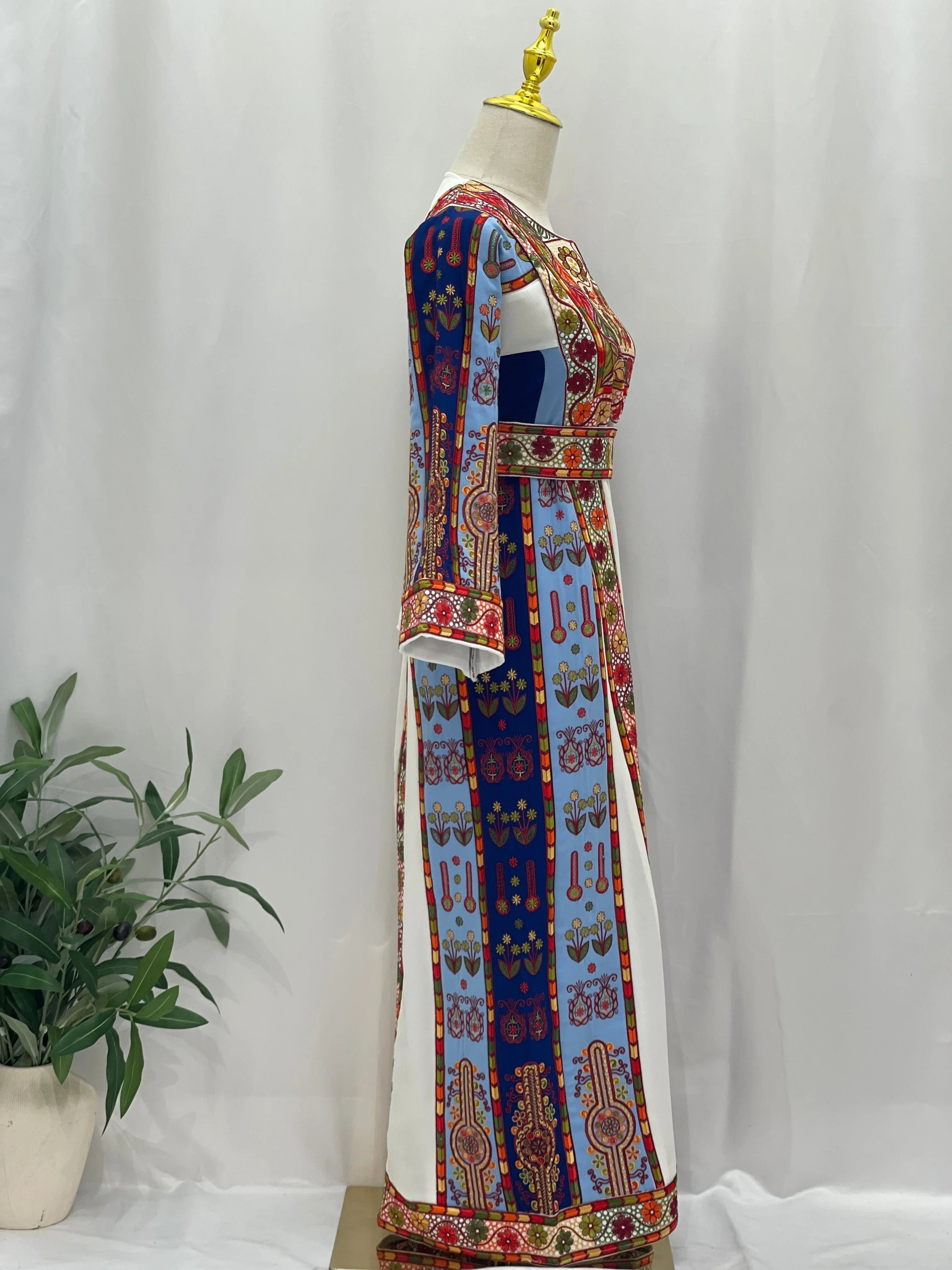 Side view of an Embroidered Girls Thoub featuring vibrant colors and intricate designs