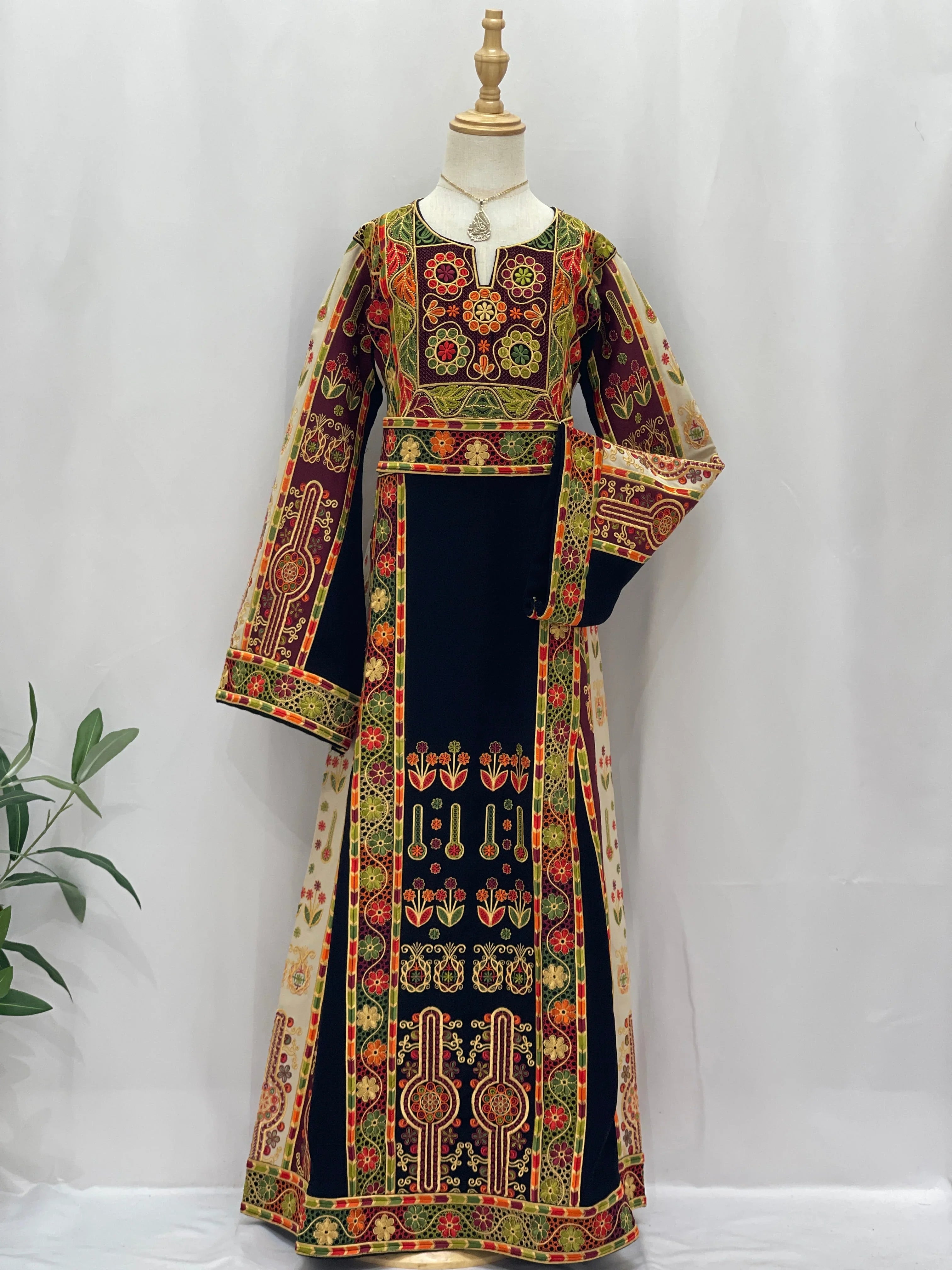 Embroidered Girls Thoub in vibrant colors with traditional Palestinian patterns and elegant design