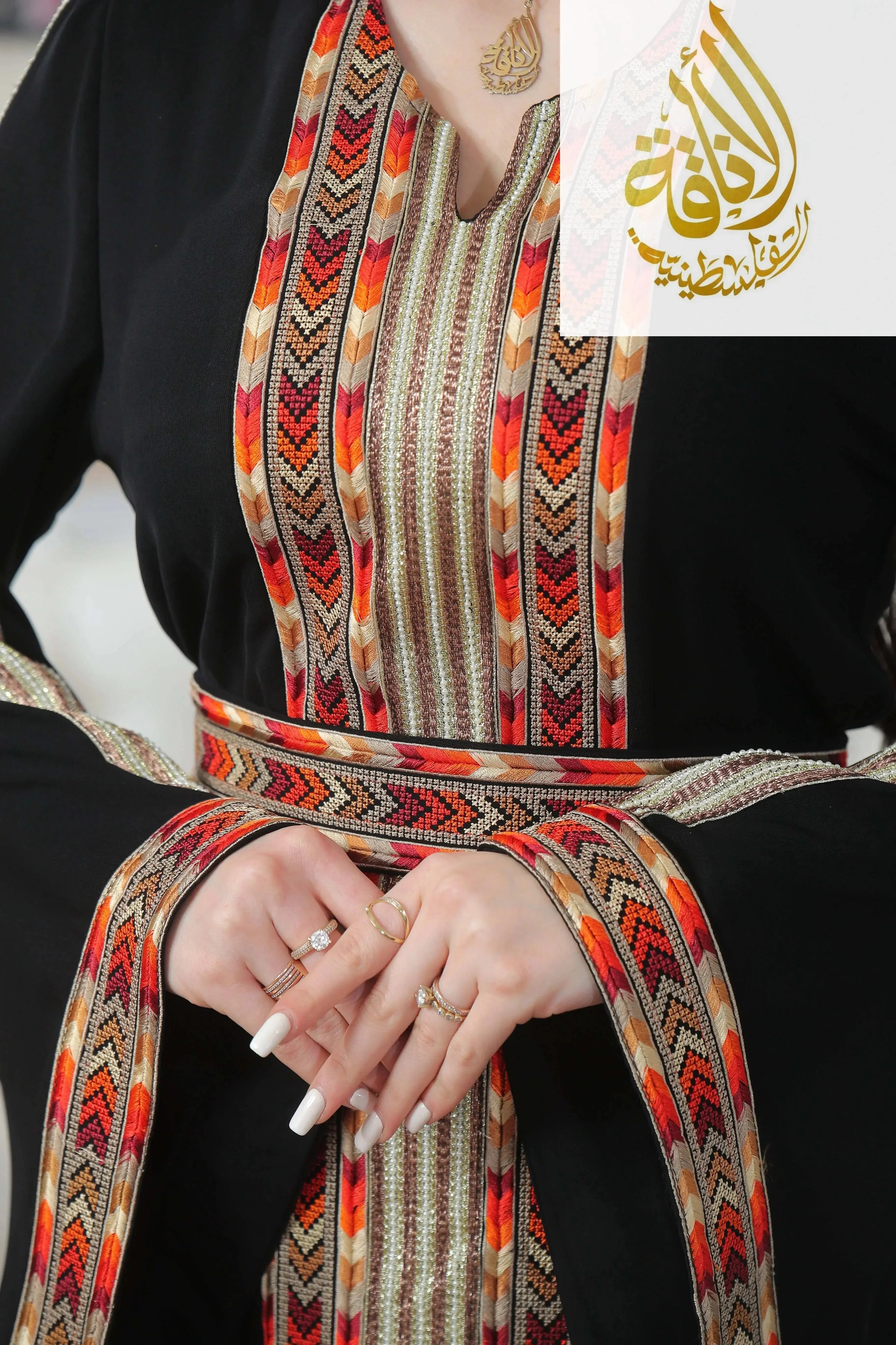 Palestinian Elegance Zena Embroidered Thoub with colorful geometric patterns on black fabric