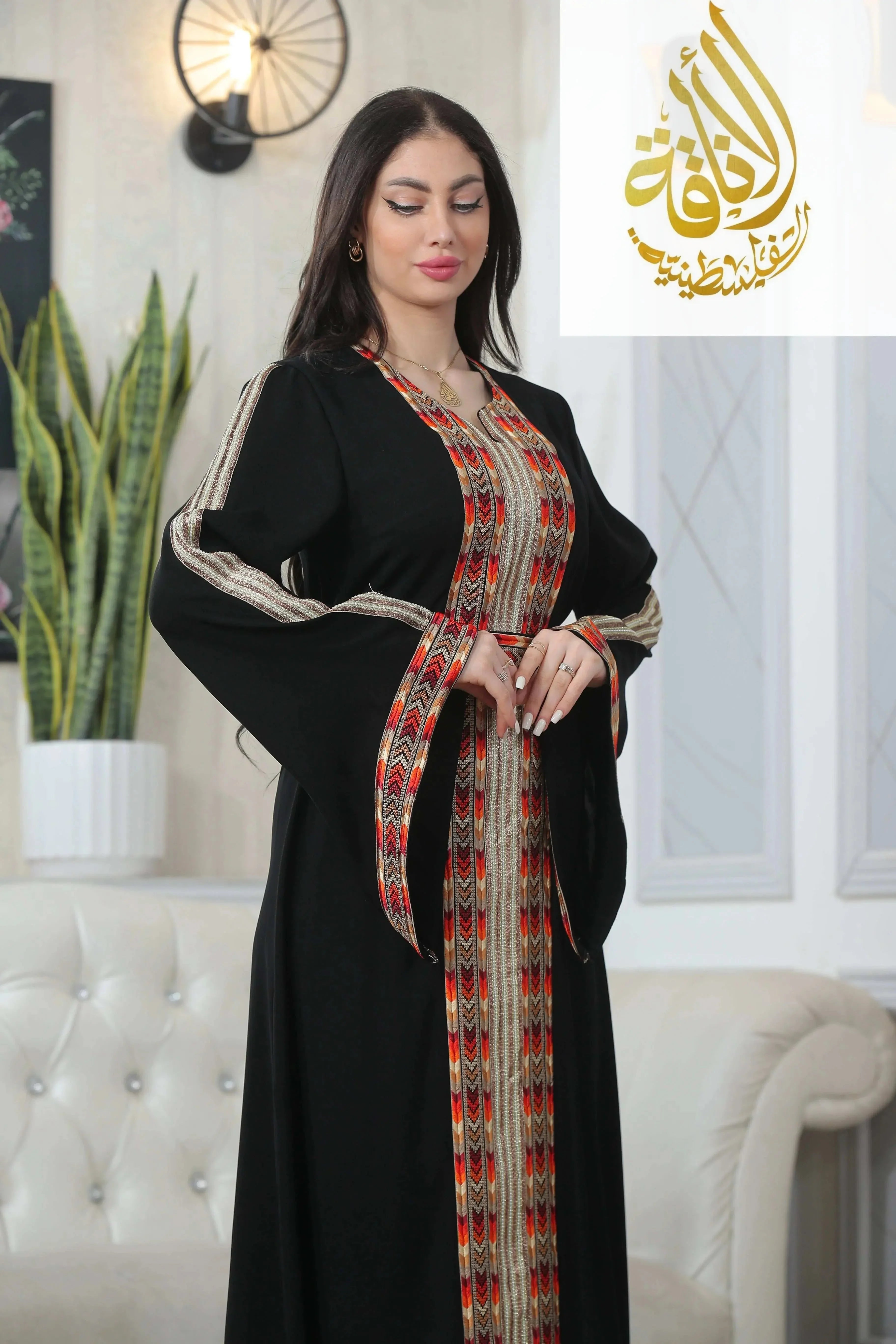 Palestinian Elegance Zena Embroidered Thoub in black with multicolor traditional embroidery worn by woman