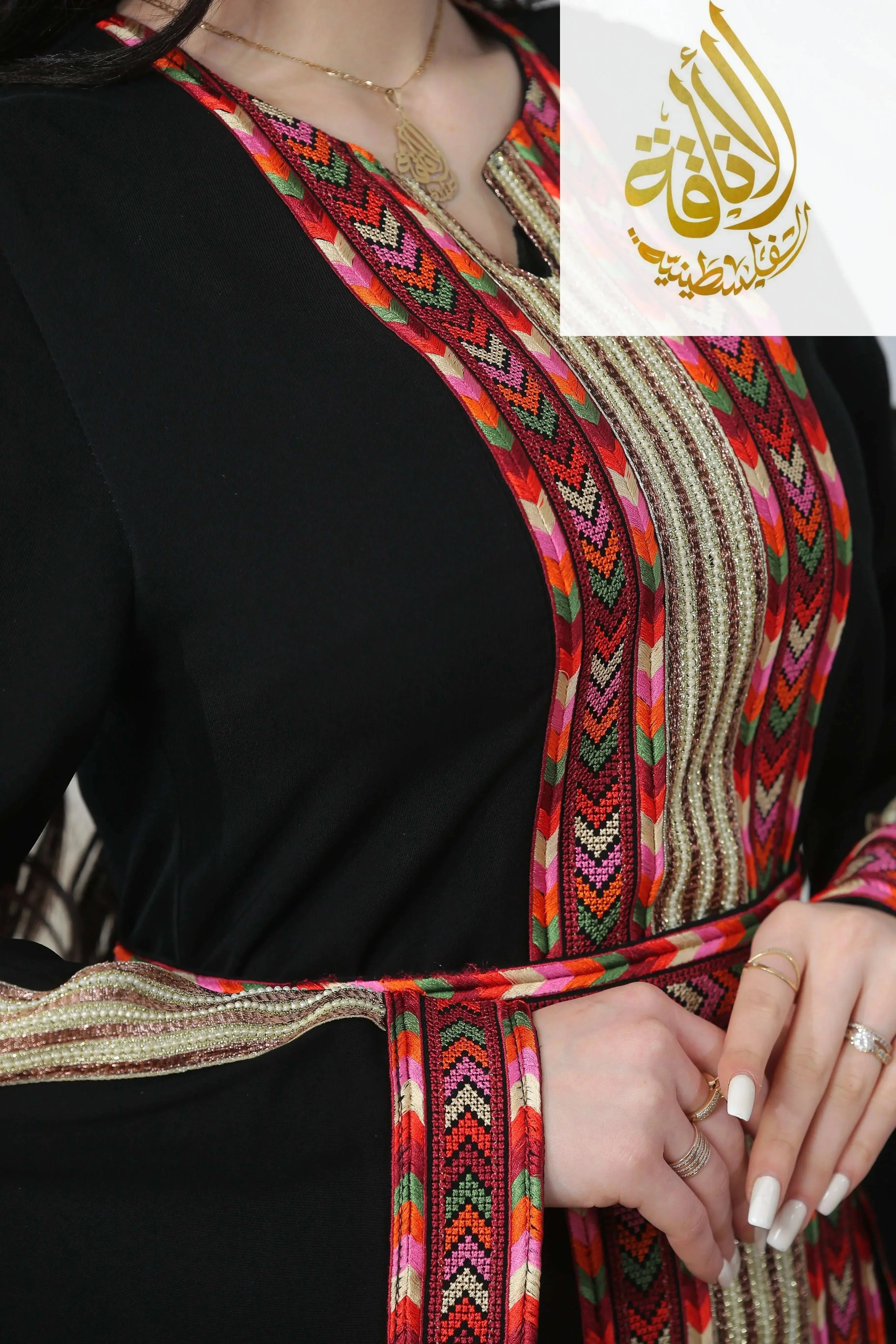 Palestinian Elegance Zena Embroidered Thoub with colorful geometric embroidery on black fabric