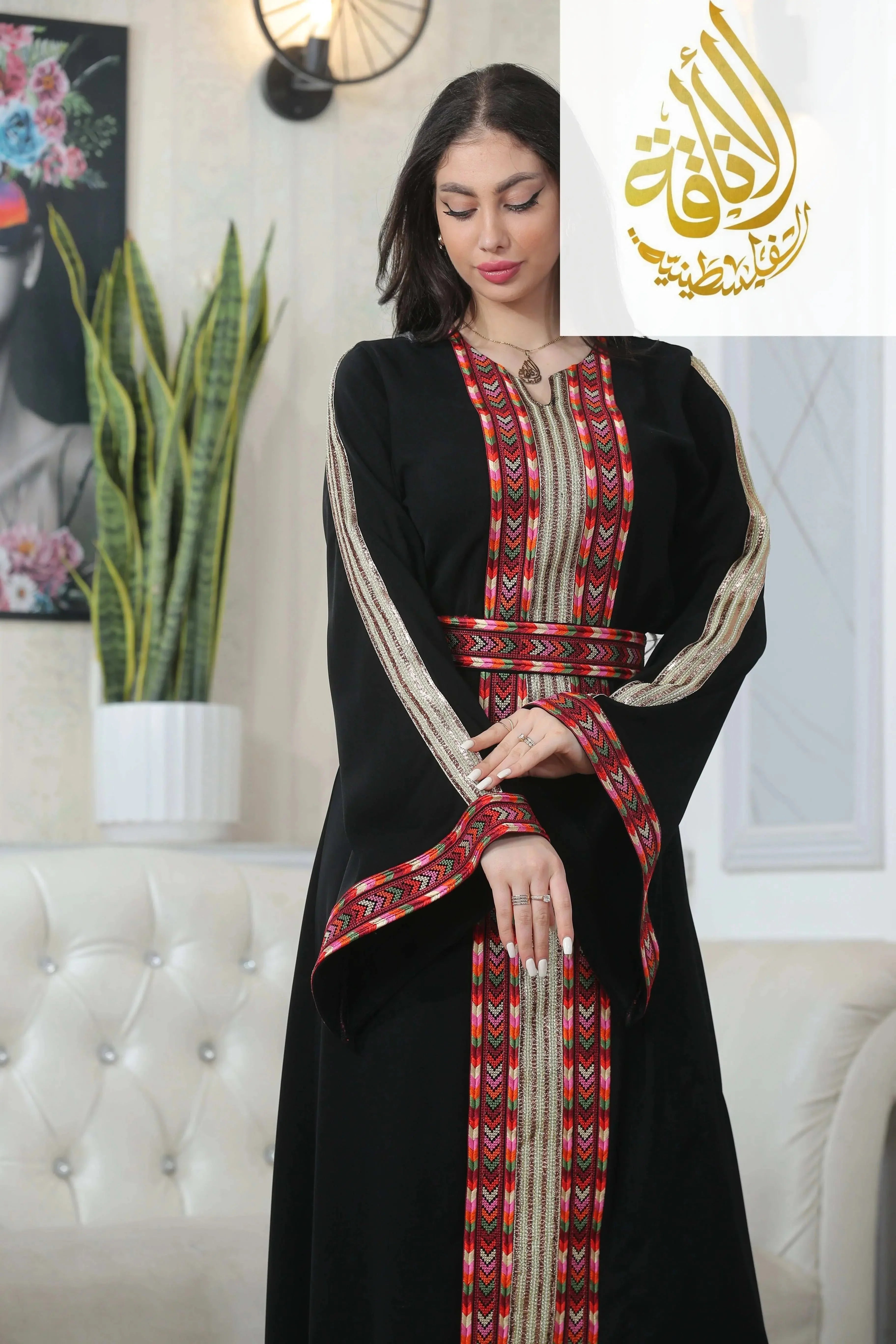 Palestinian Elegance Zena Embroidered Thoub in black with red and gold detailed embroidery on sleeves and front