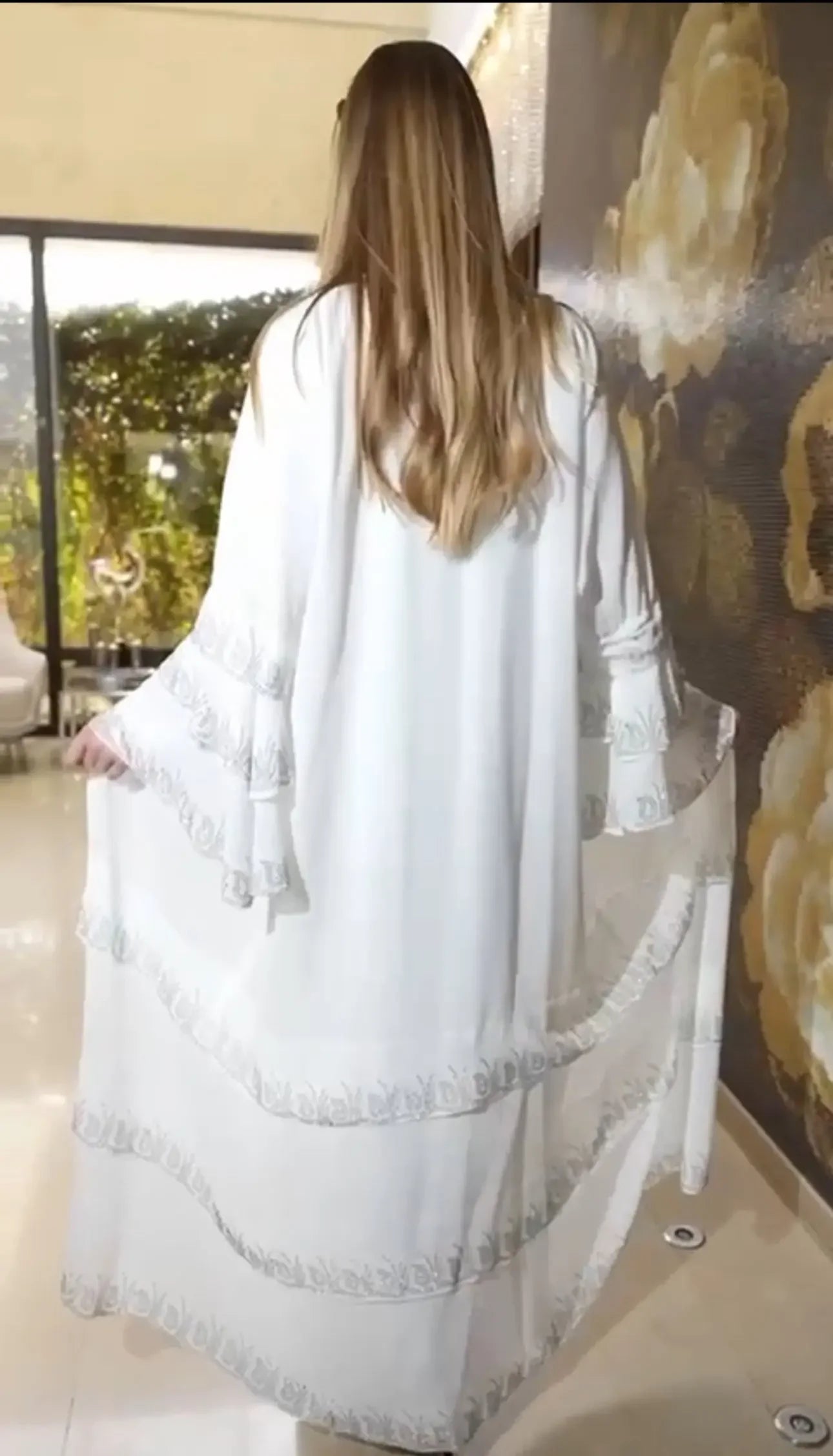 Palestinian Elegance white abaya with strass embellishments featuring delicate trim details on sleeves and hem