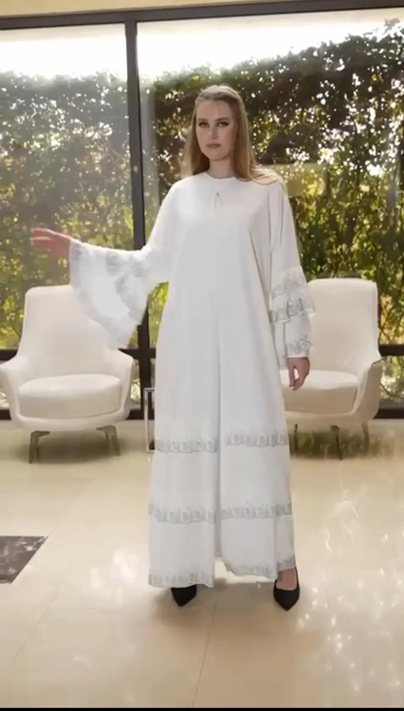 Palestinian Elegance white abaya with strass embellishments on sleeves and hem, worn by model