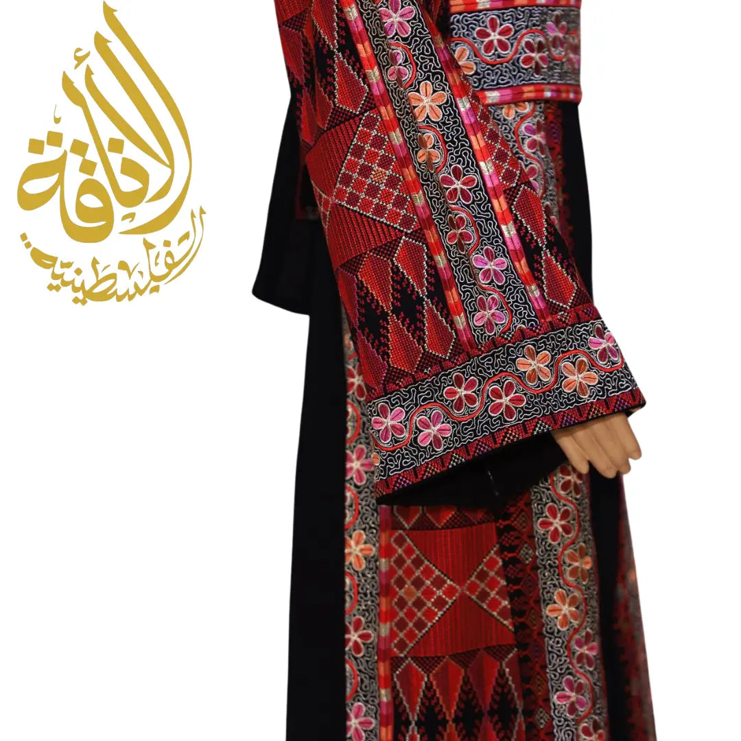 Close-up of Palestinian embroidered thobe dress sleeve and side panel with intricate red and pink embroidery