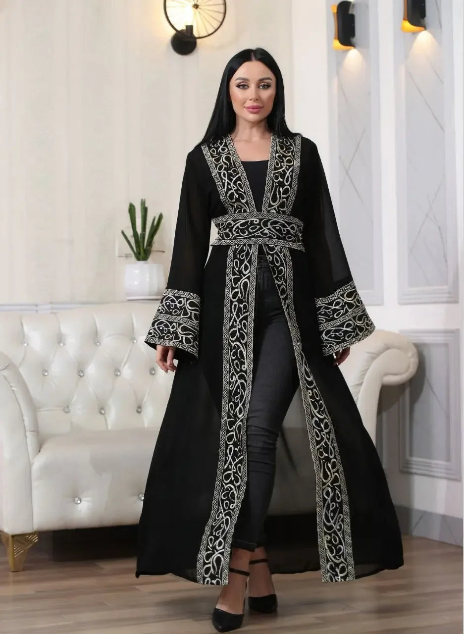 Palestinian Elegance black Arabic letter embroidered cardigan with intricate silver embroidery worn by a woman