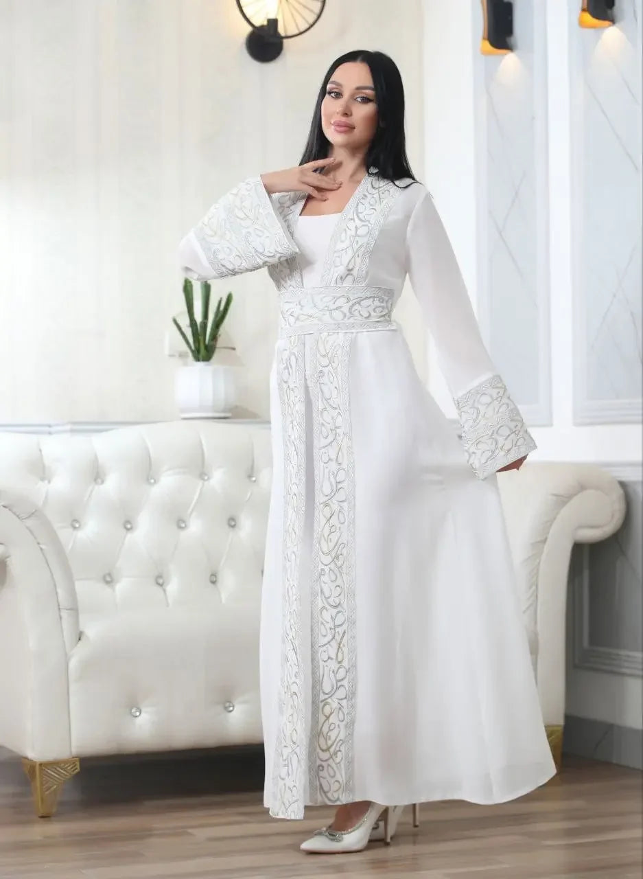 White Arabic letter embroidered cardigan with intricate embroidery worn by a woman in an elegant setting