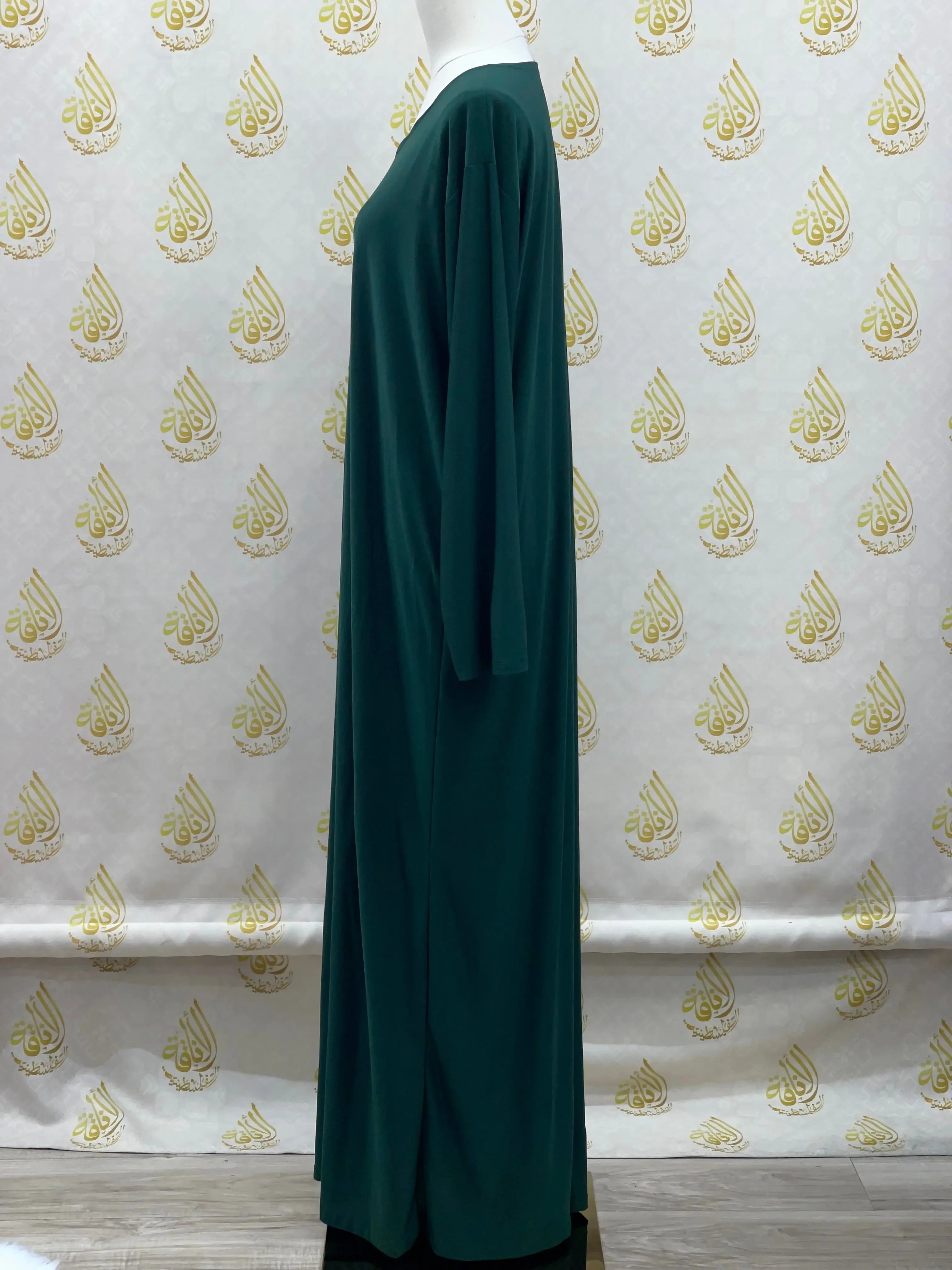 Palestinian Elegance basic solid dress in dark green with long sleeves and modest full length design