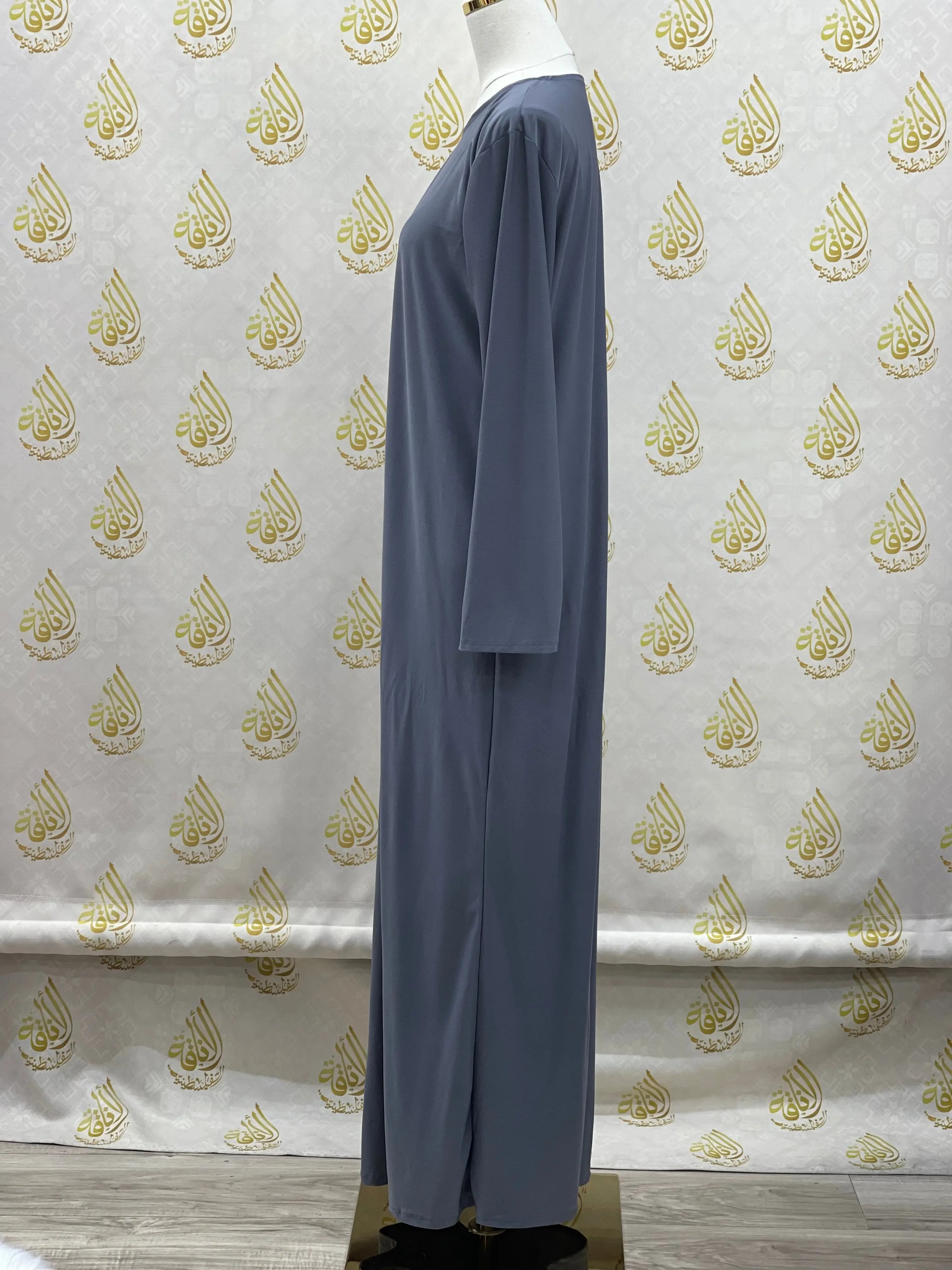 Palestinian Elegance basic solid dress in blue long sleeve side view on mannequin