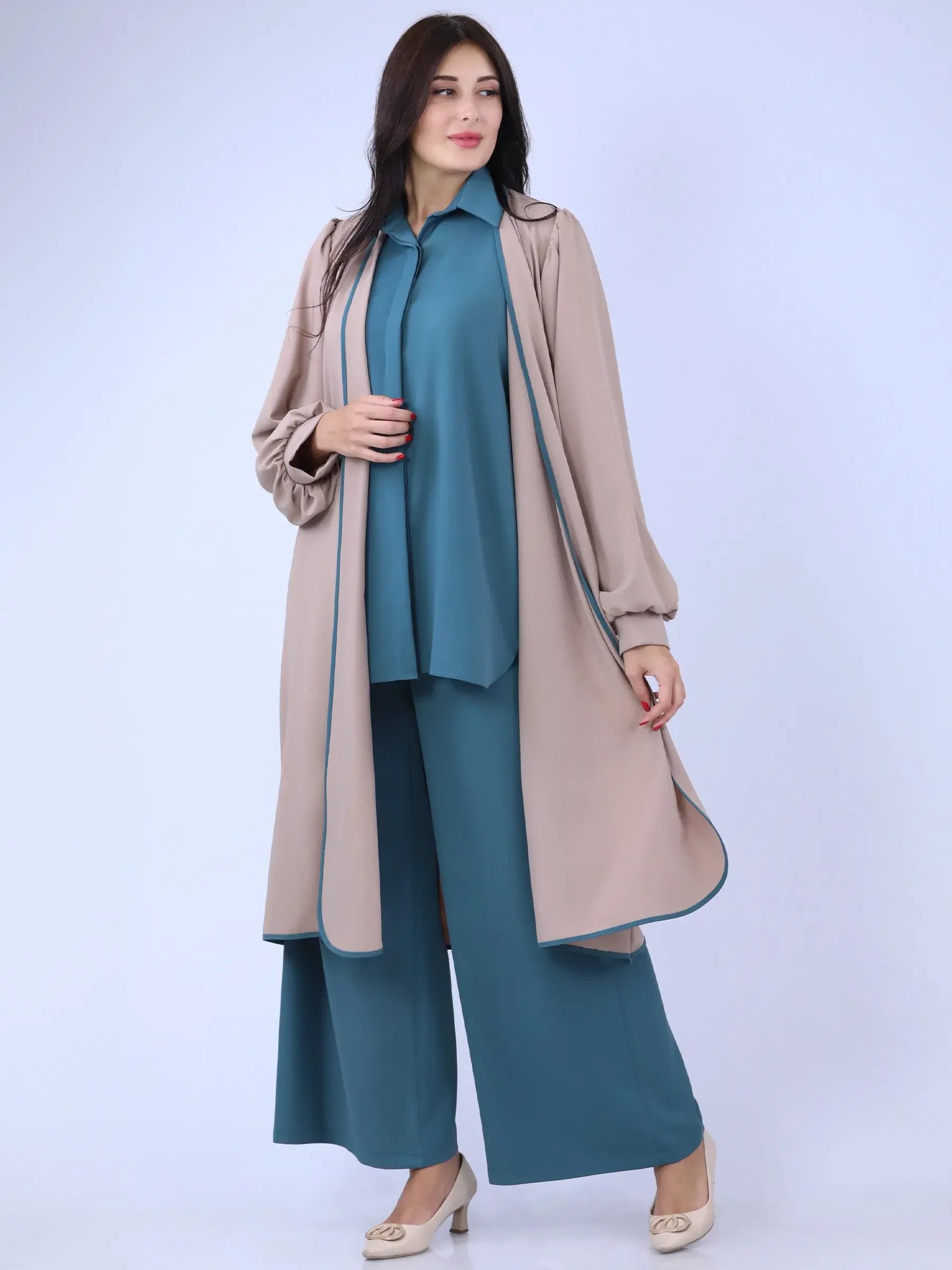 Palestinian Elegance beige long cardigan worn over teal wide-leg pants and matching top with heels
