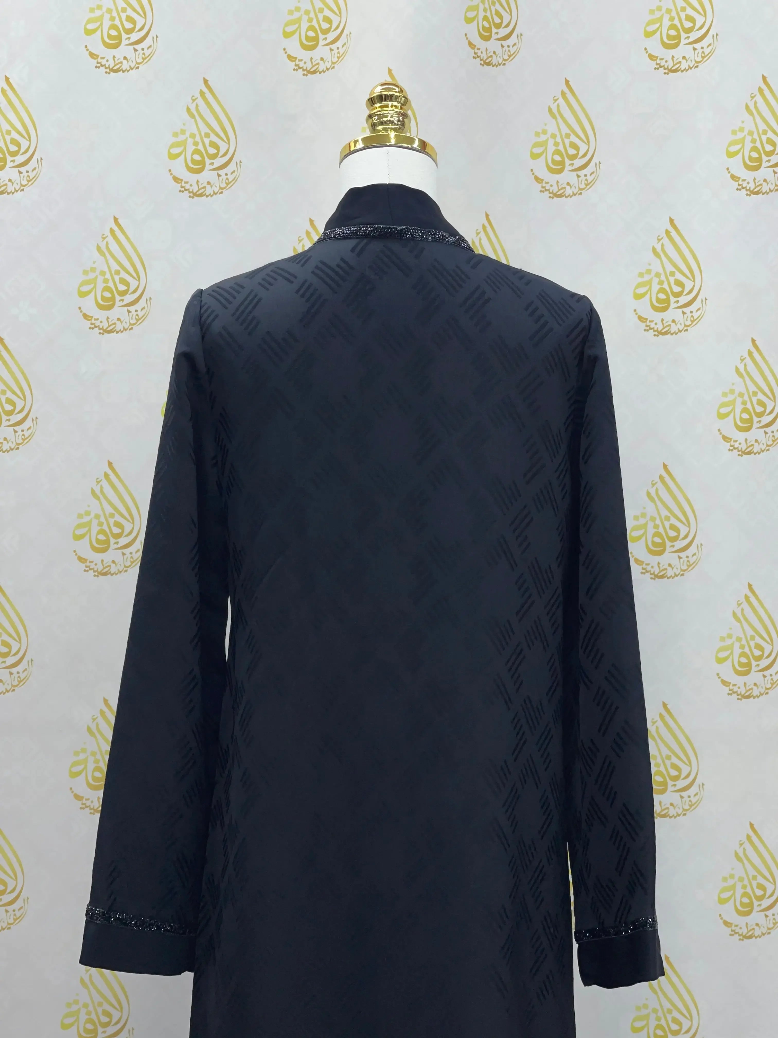 Back view of black abaya for women with subtle pattern and embroidered cuffs from Palestinian Elegance