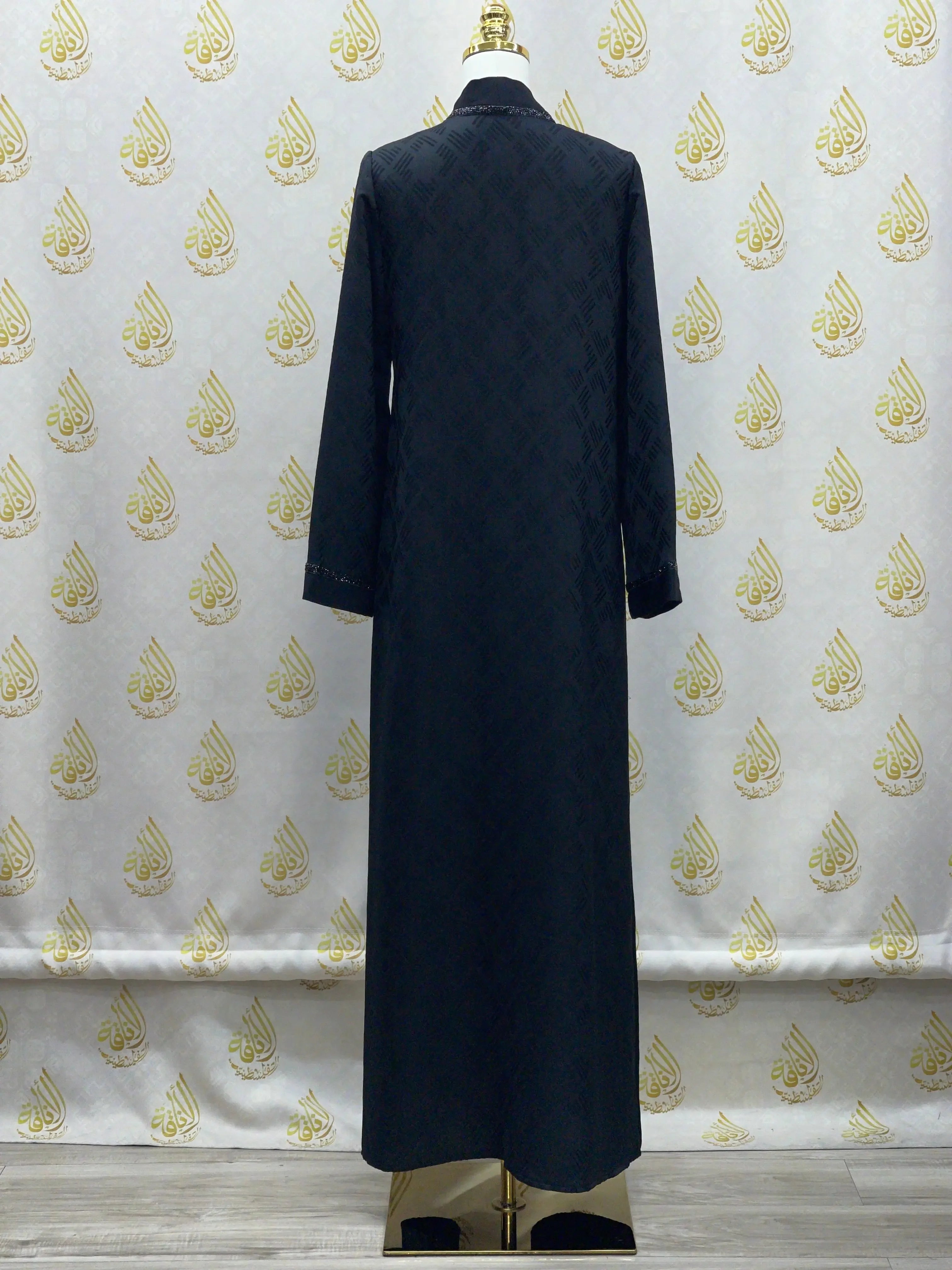 Palestinian Elegance black abaya for women displayed on mannequin with long sleeves and full length design