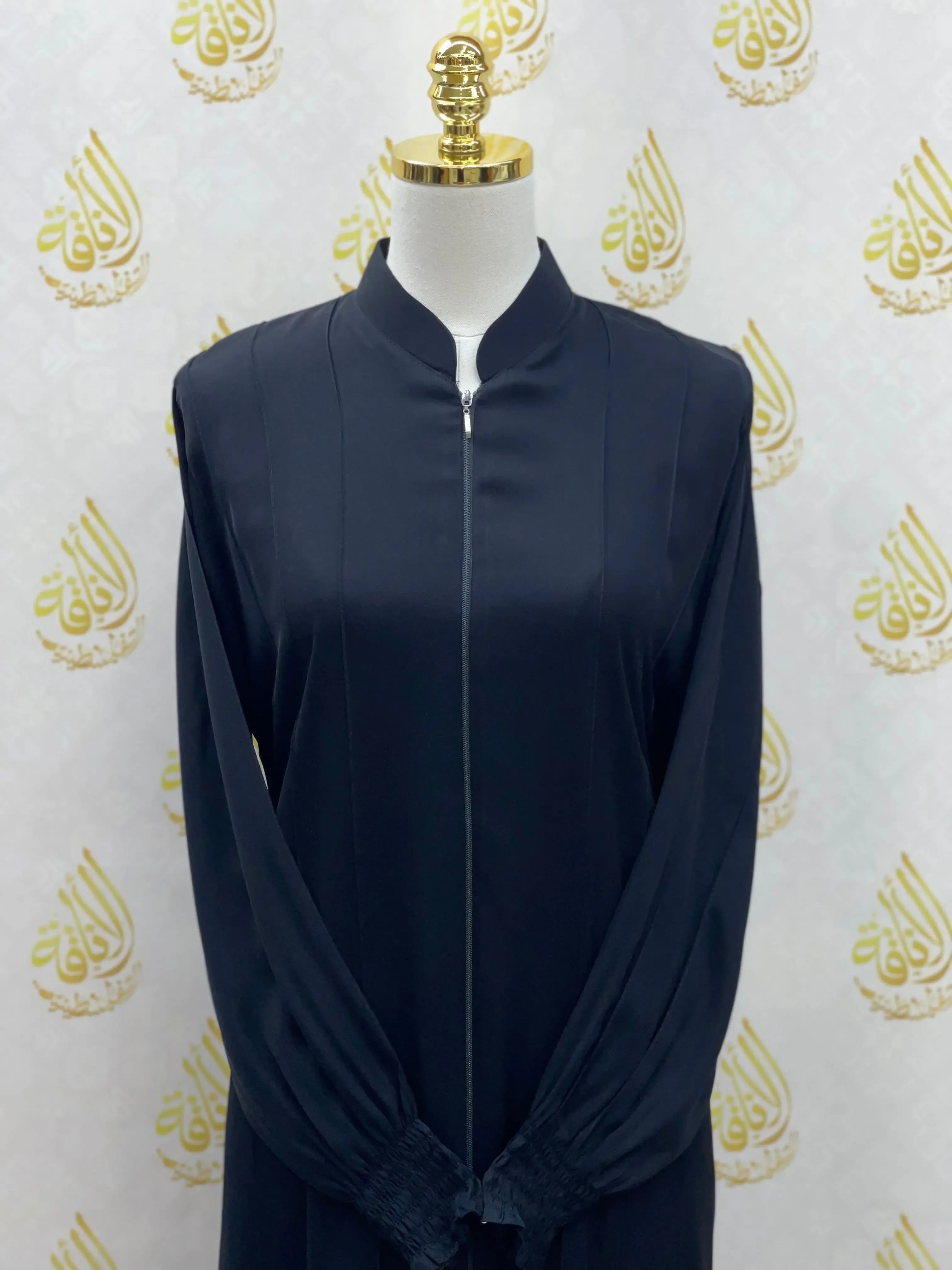 Palestinian Elegance black abaya with embroidery featuring a front zipper and long sleeves on a mannequin