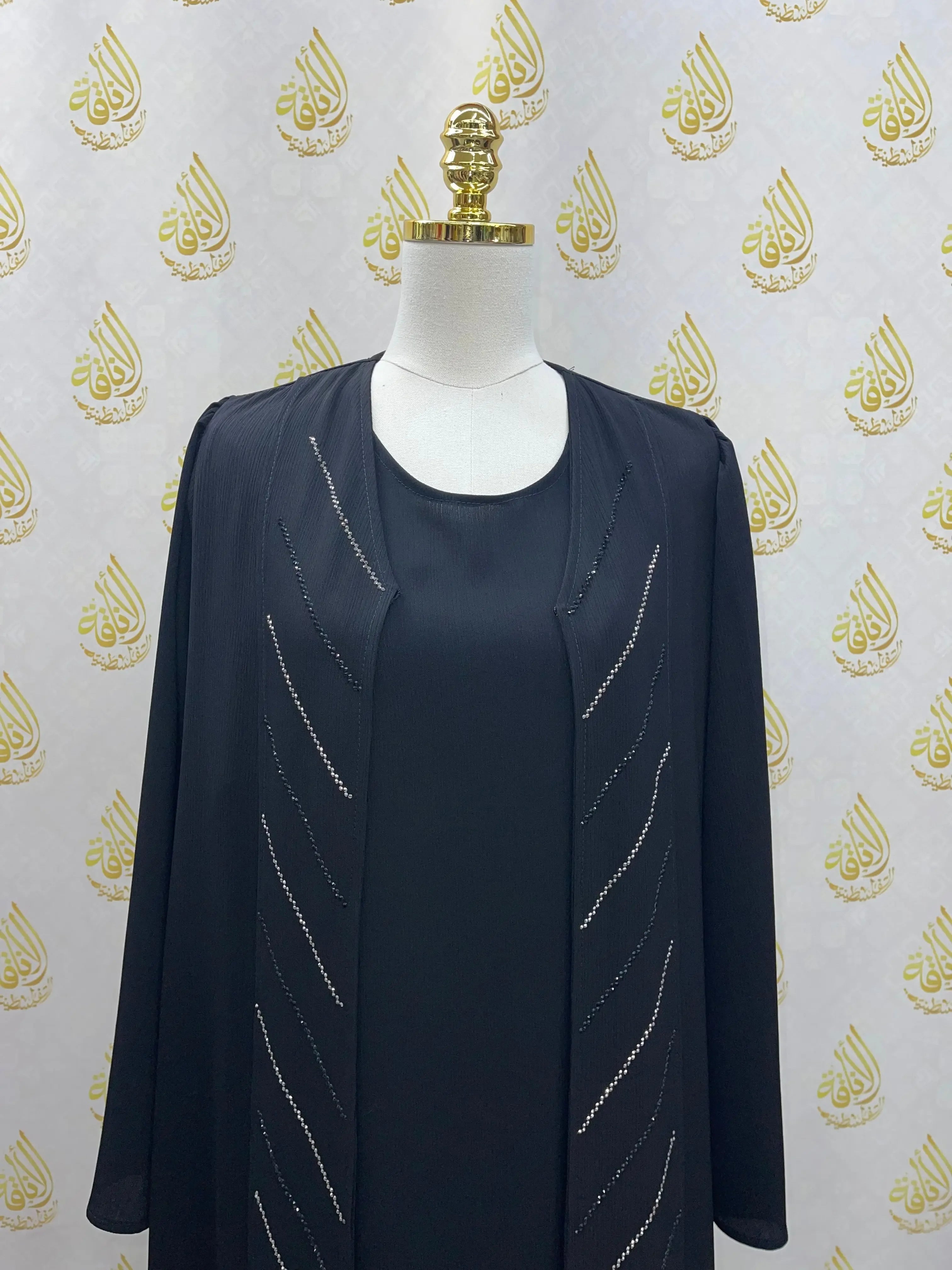 Black Abaya with Strass detailing on front displayed on mannequin by Palestinian Elegance
