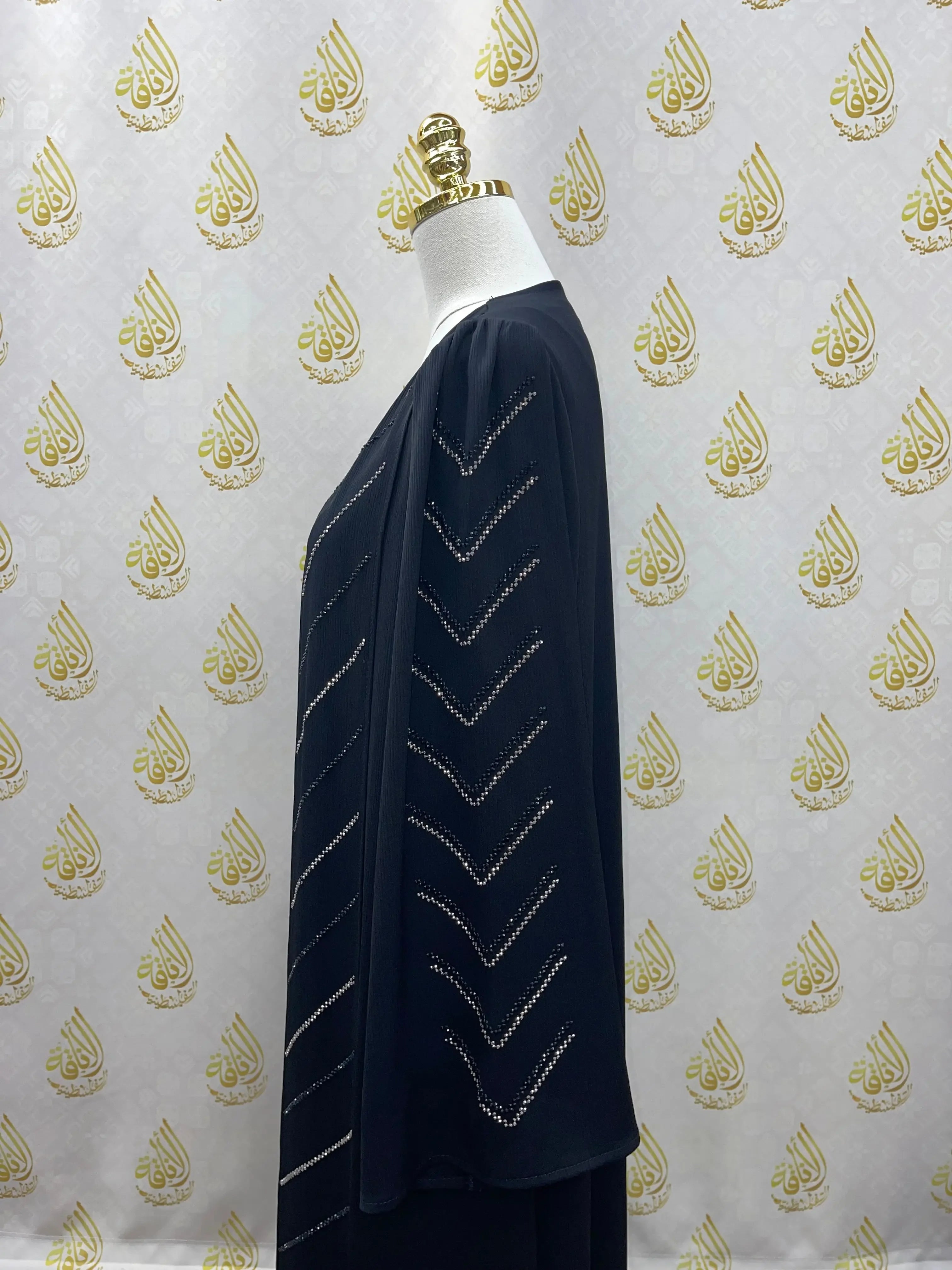 Black Abaya with Strass by Palestinian Elegance displayed on a mannequin with detailed rhinestone patterns