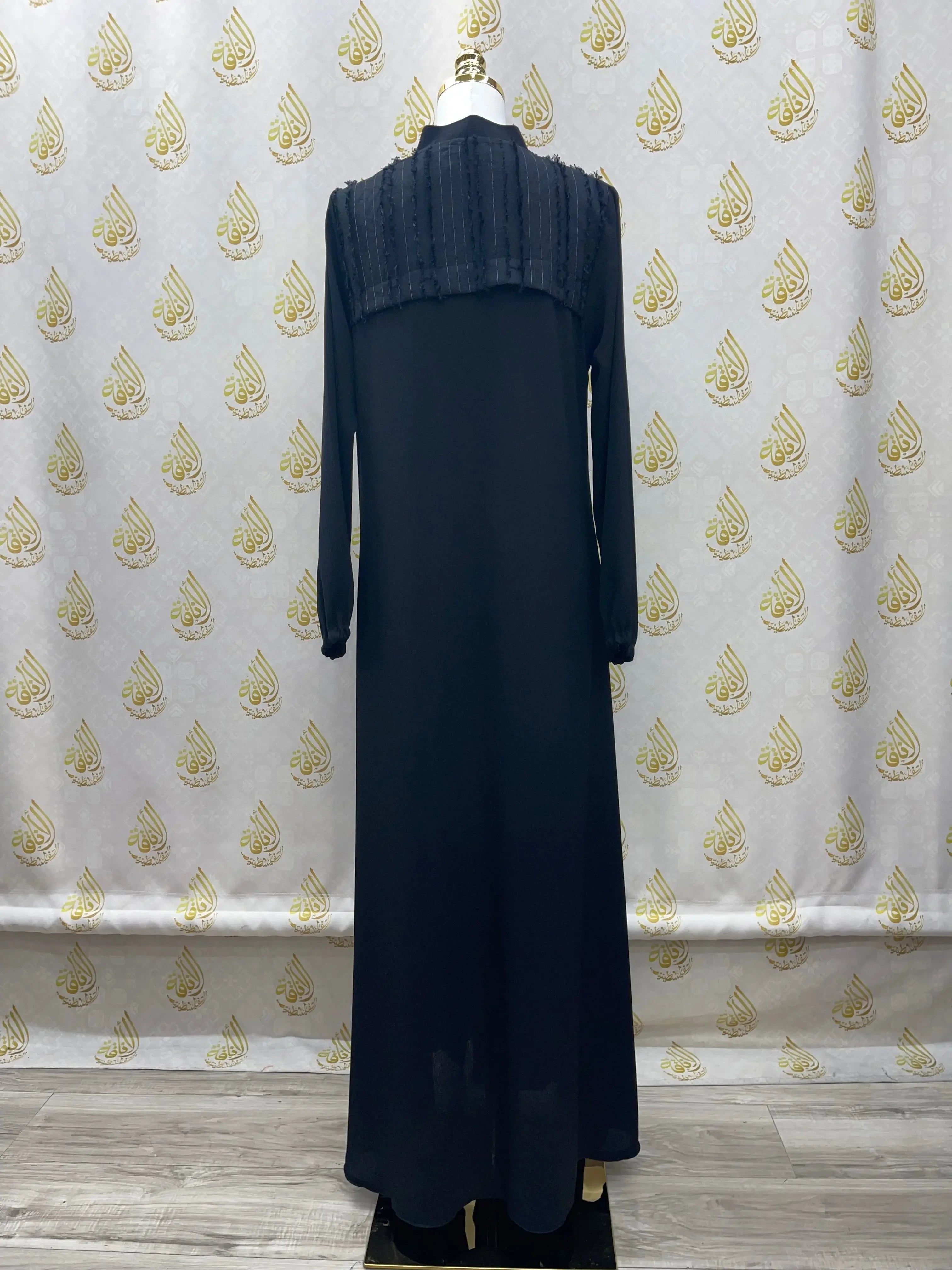 Black casual abaya for women with long sleeves and textured upper back detail by Palestinian Elegance