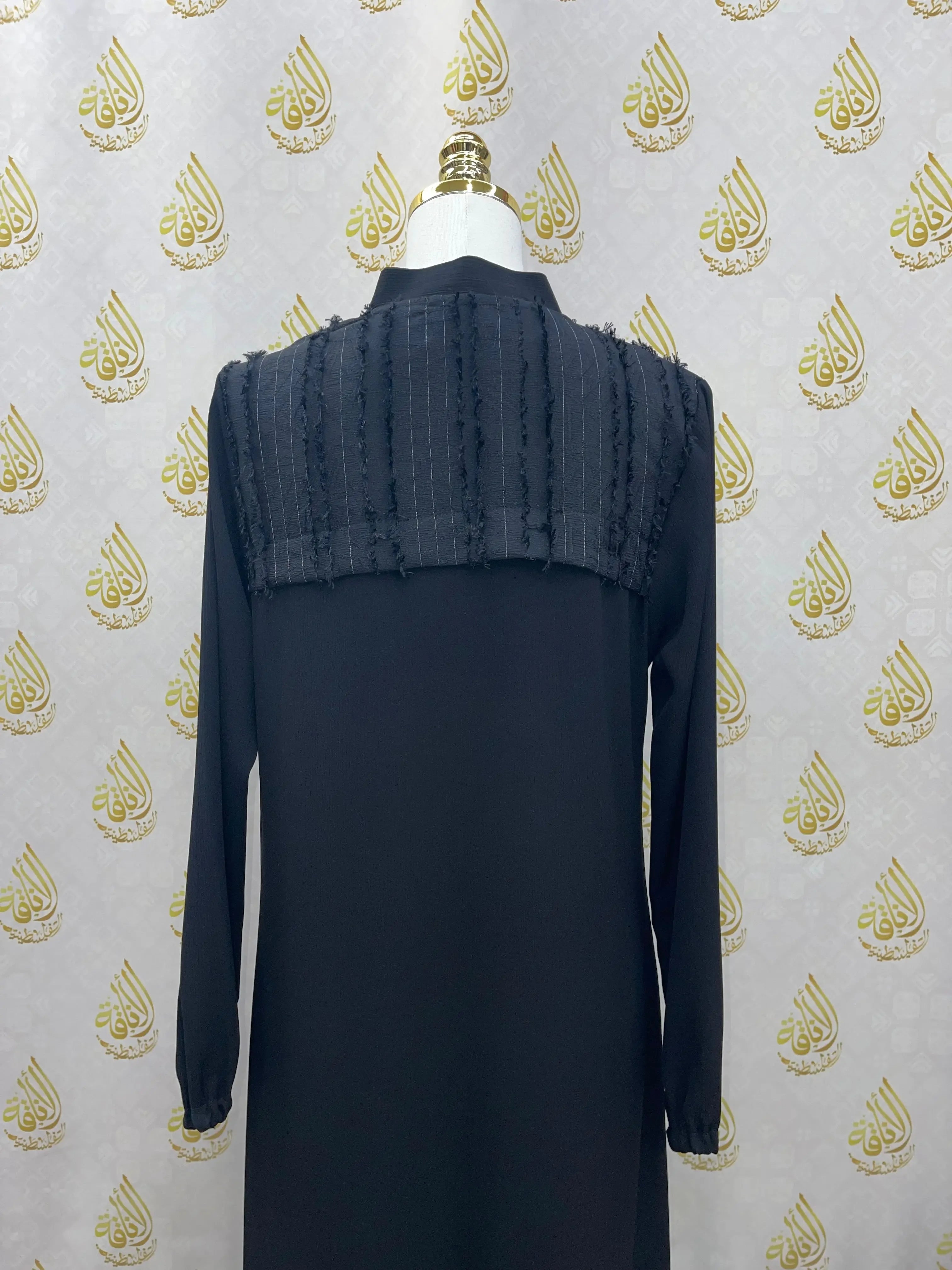 Black casual abaya for women with long sleeves and textured shoulder detail by Palestinian Elegance